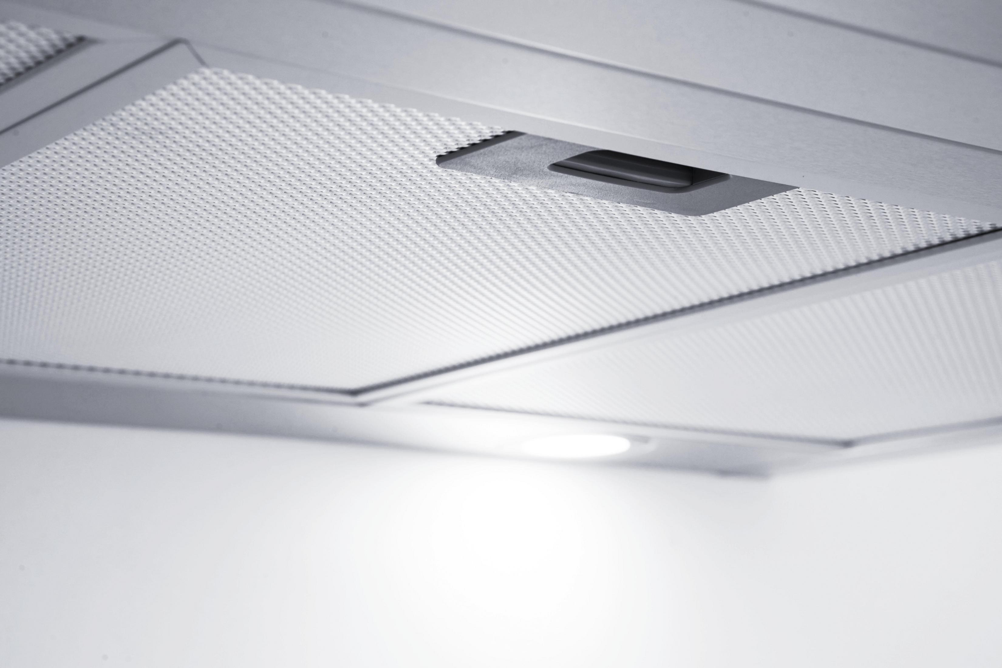 Close-up of the bottom of a range hood, showing a filter grid.