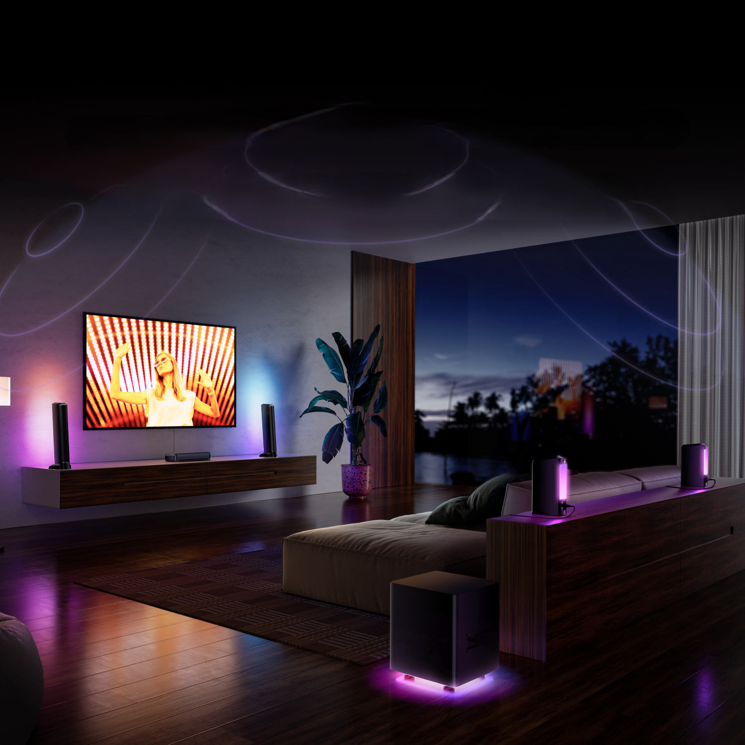 Salon z telewizorem, głośnikami i światłami tworzącymi kolorową atmosferę. Osoba ogląda telewizję.