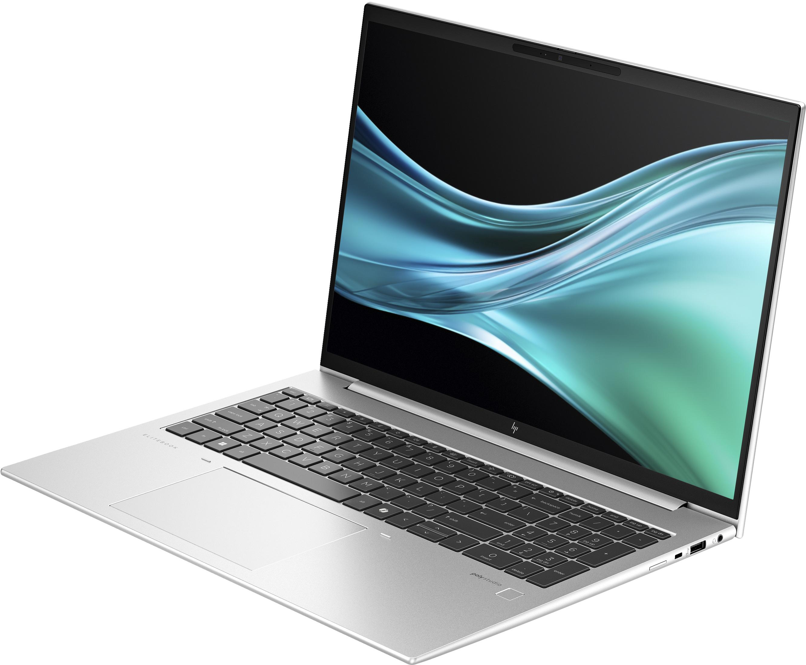 Otwarty srebrny laptop na białym tle. Ekran wyświetla abstrakcyjny wzór fal. Widoczna klawiatura i touchpad.