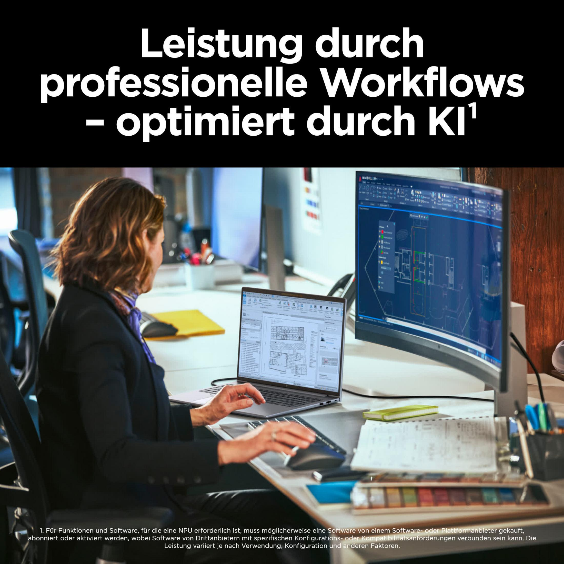 Frau arbeitet an einem Laptop und einem großen Monitor. Auf dem Schreibtisch liegen Papiere und ein Stifthalter.
