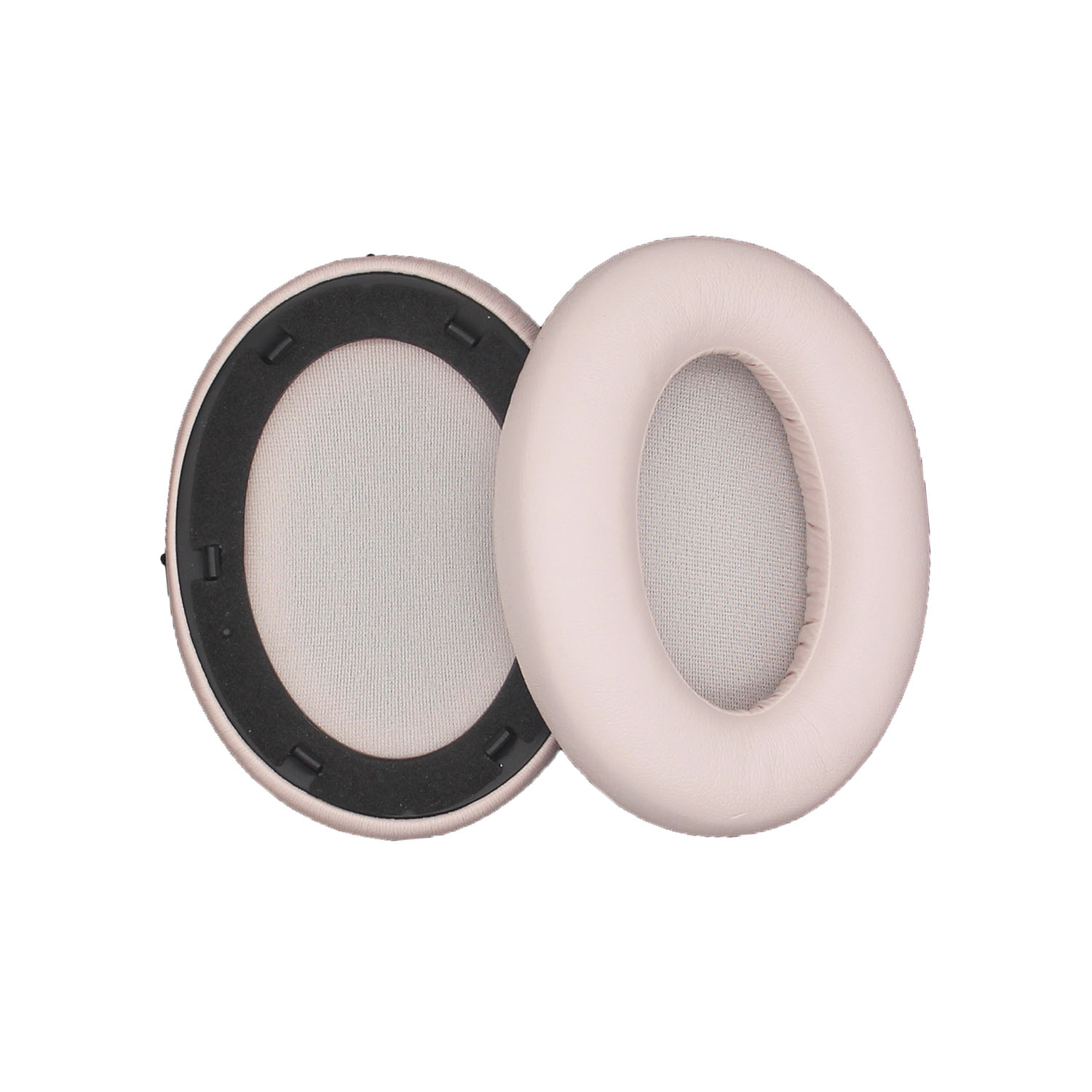 Due cuscinetti auricolari rosa chiaro. Uno ha l'interno visibile con un contorno nero. Sfondo bianco.