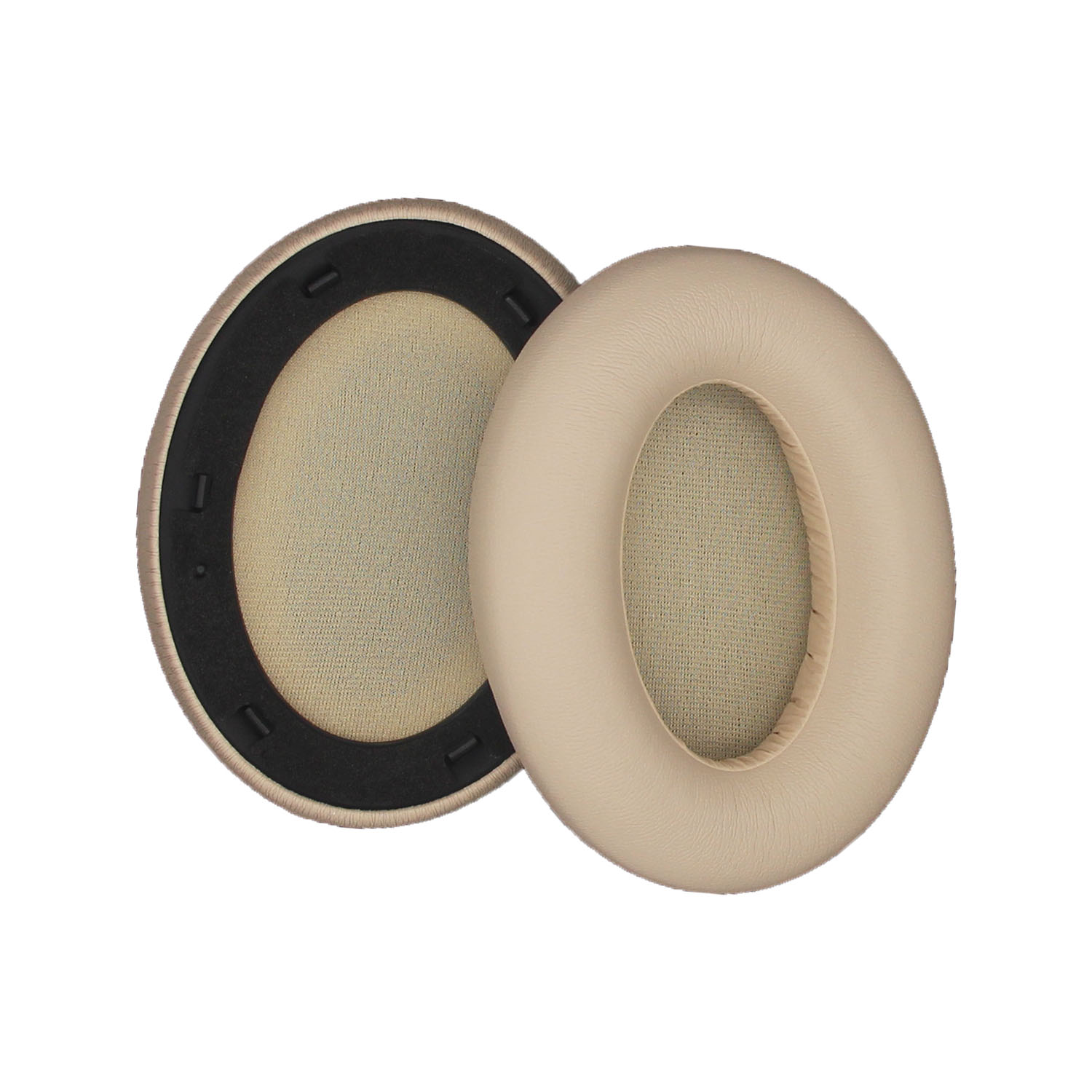 Due cuscinetti auricolari beige con anelli neri. Hanno forma ovale.