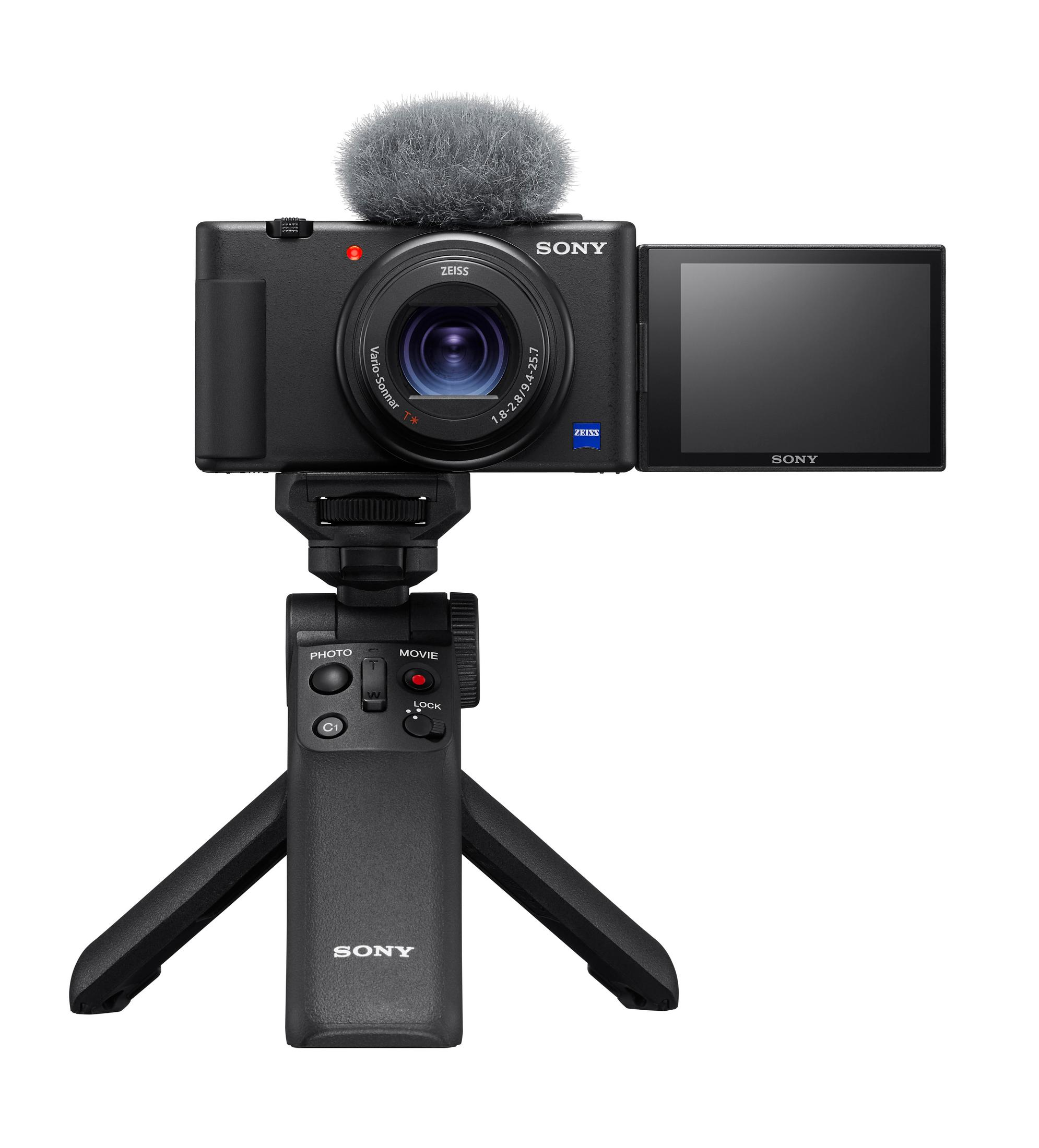 Zwarte camera op statief, microfoon bovenop, scherm open, knoppen.