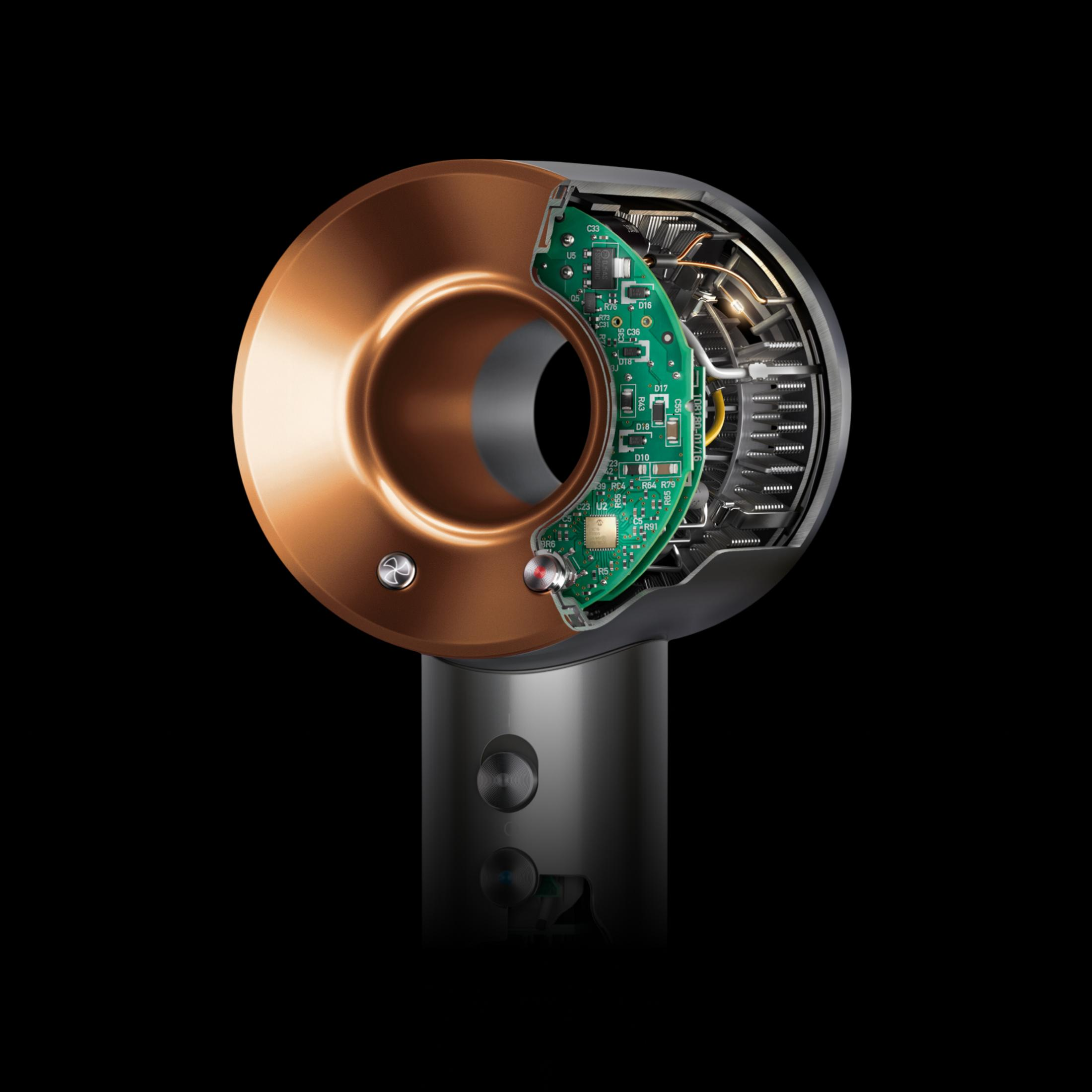 Przekrój suszarki do włosów Dyson, pokazujący wewnętrzne elementy, ze szczegółami w kolorze miedzi i zieleni.