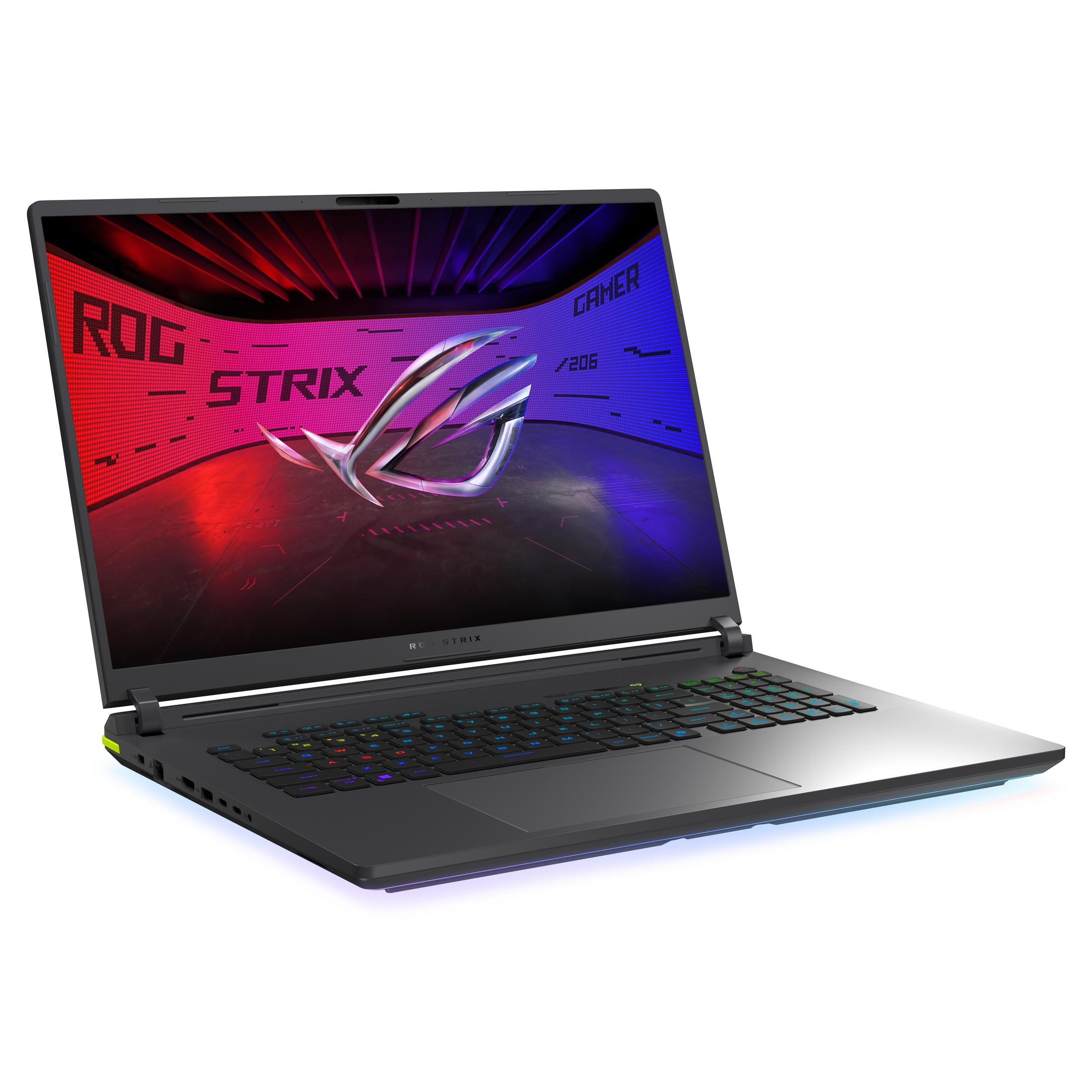 Szary laptop, otwarty. Logo ROG Strix na ekranie, kolorowa klawiatura. Czerwono-niebieskie tło.