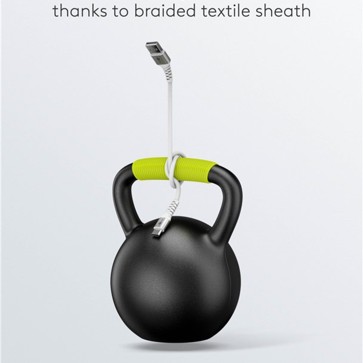 White cable looped around a kettlebell with green handle.
