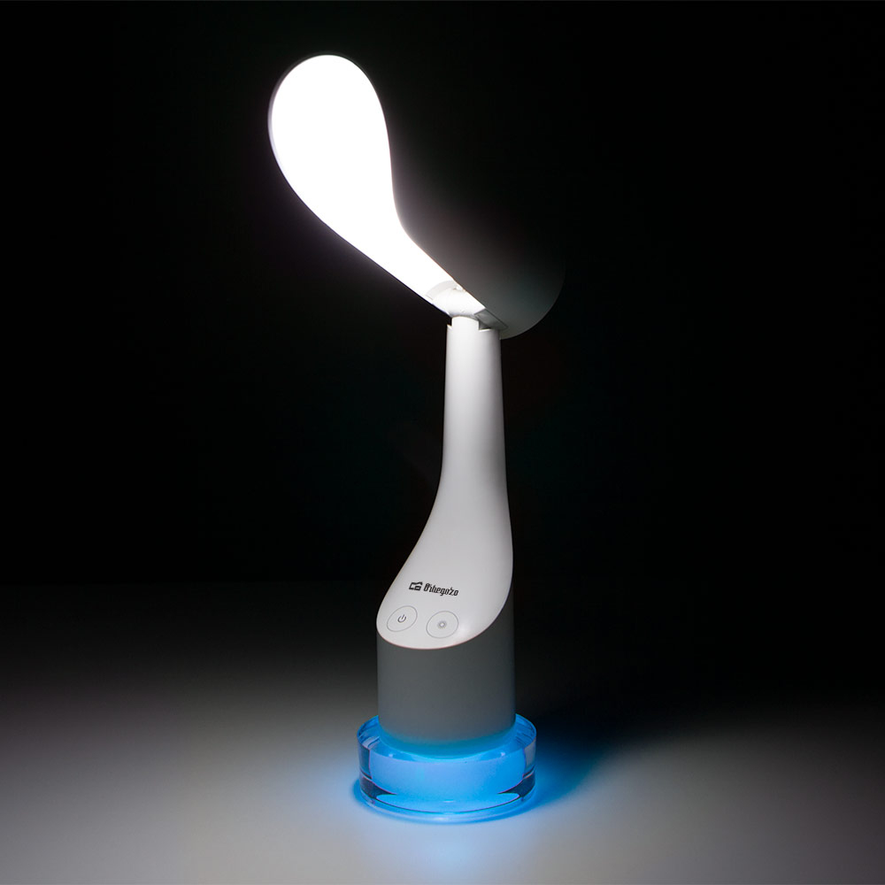 Lámpara de escritorio blanca iluminada, con luz base azul. Fondo oscuro.