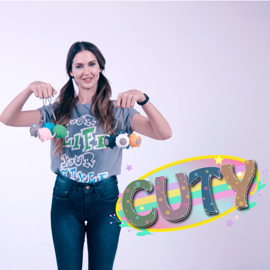 A woman holding colorful toys, with a logo that says 'CUTY'.