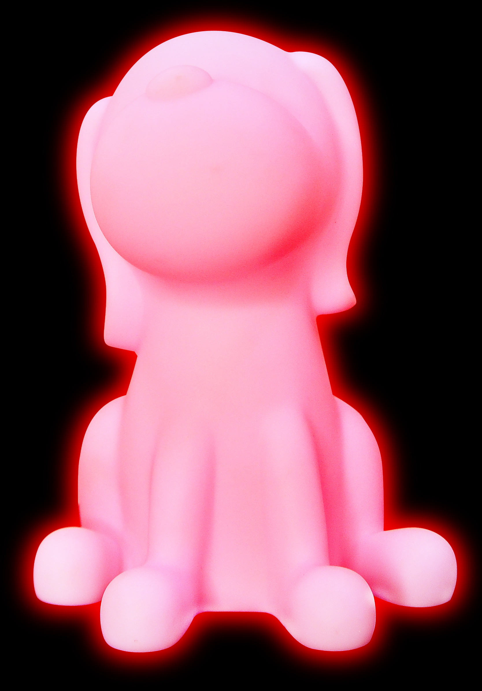 Een roze oplichtende hondvormige lamp op een zwarte achtergrond.