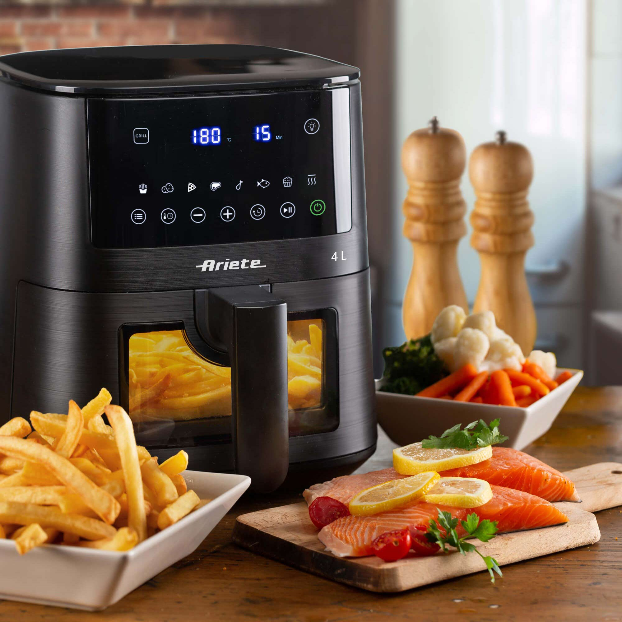 Czarna frytkownica powietrzna z wyświetlaczem cyfrowym, frytkami, łososiem i warzywami na drewnianym stole.