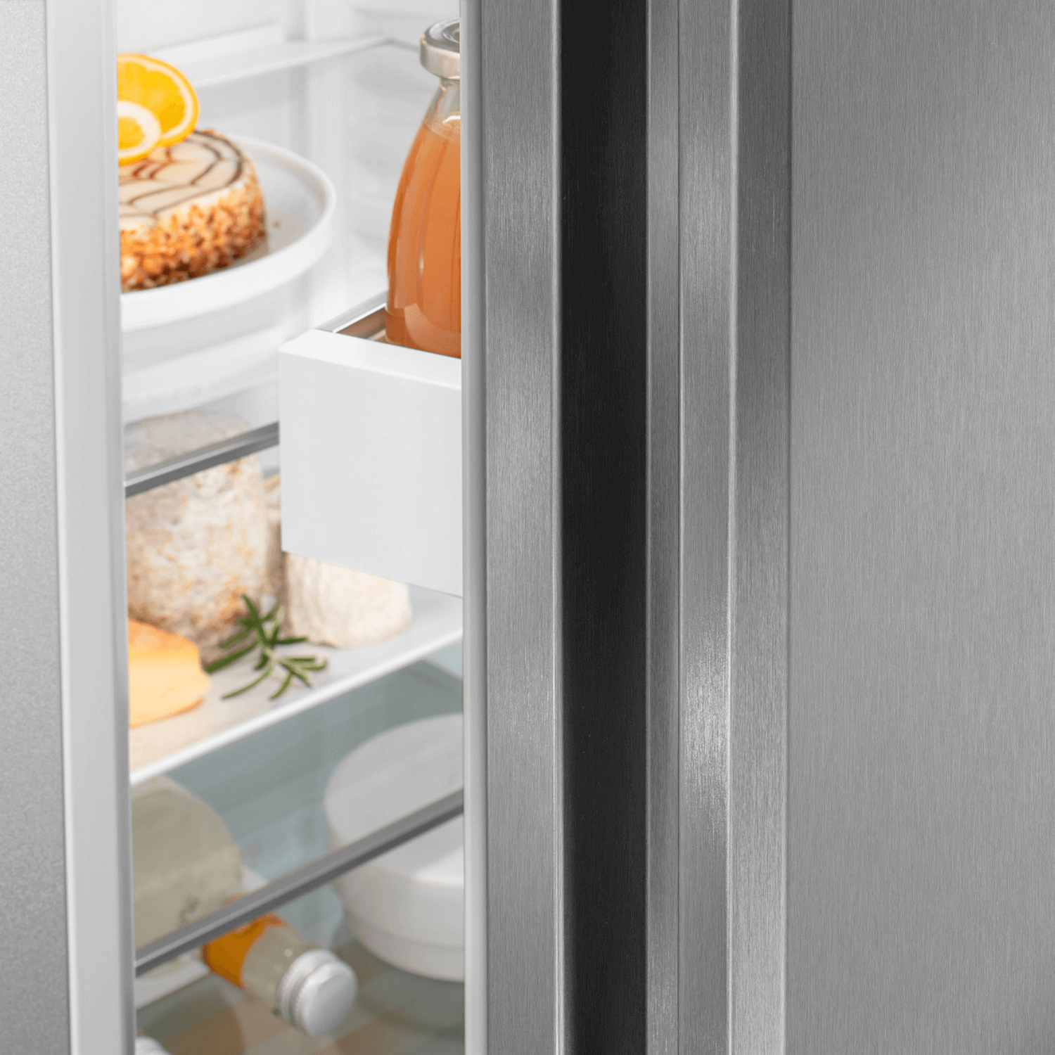 Primo piano dell'interno del frigorifero Liebherr. Vengono conservati alimenti, tra cui formaggio e succo.