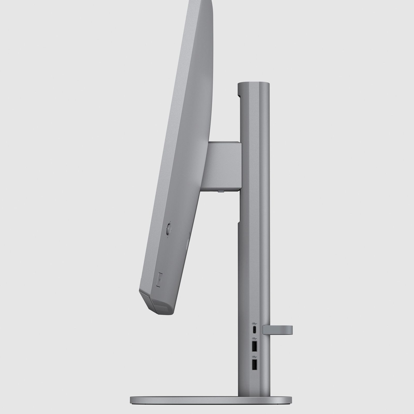 Widok z boku srebrnego monitora komputera ze stojakiem, na białym tle.
