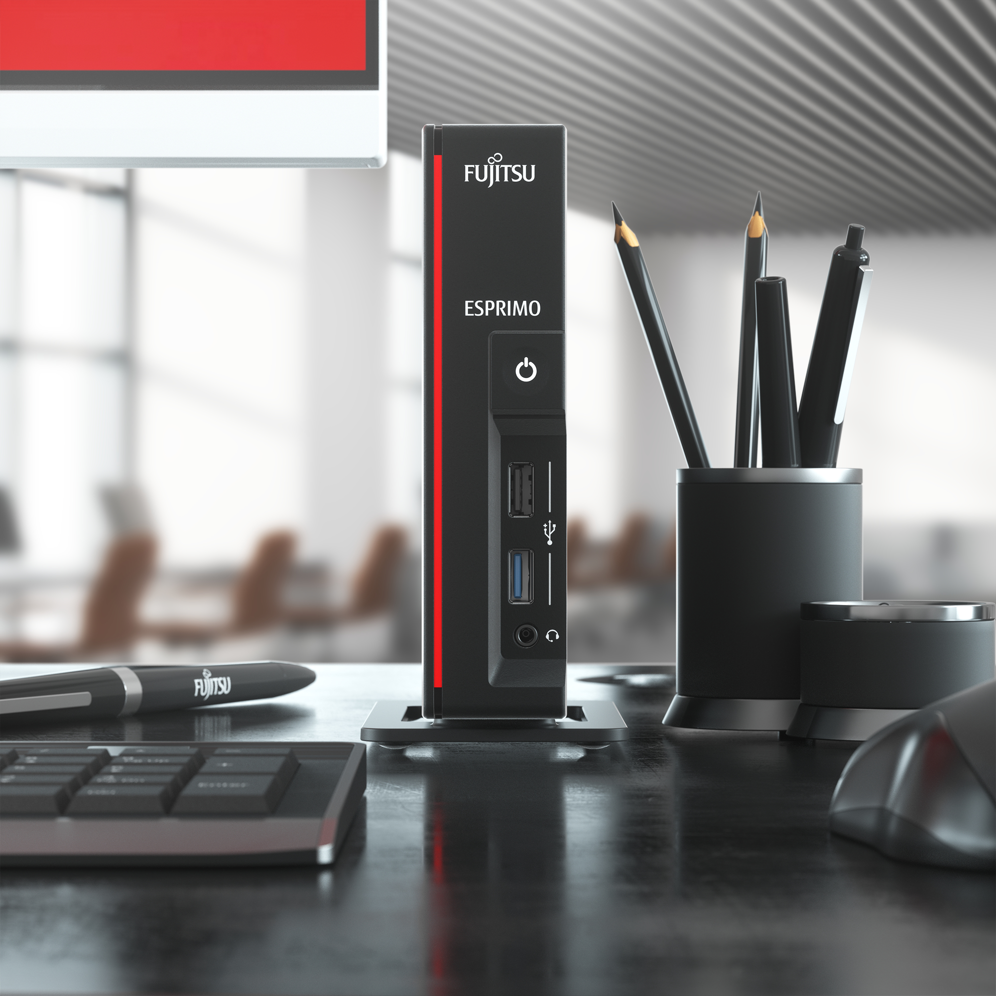 Black Fujitsu Esprimo PC. Red stripe, on a desk, with pens, mouse, keyboard, and monitor.