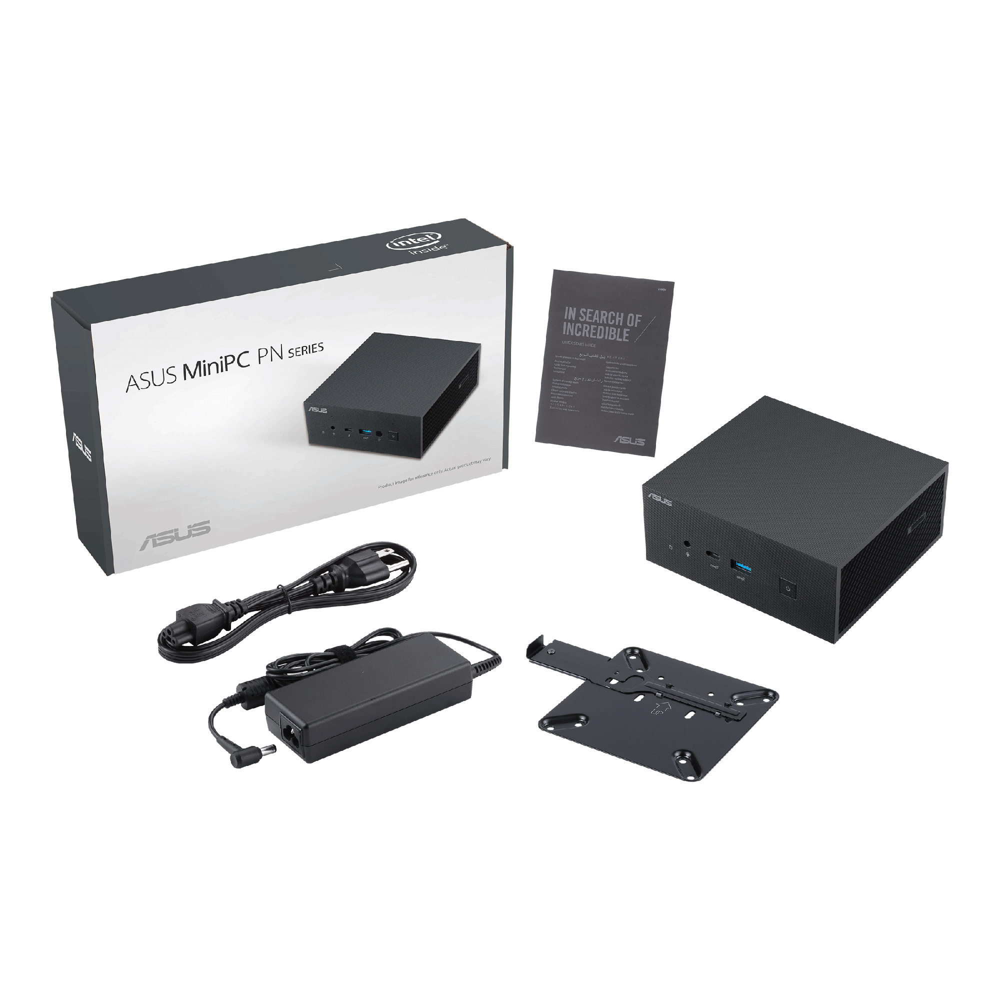 Scatola ASUS MiniPC con accessori. Scatola, alimentatore e altri componenti visibili.