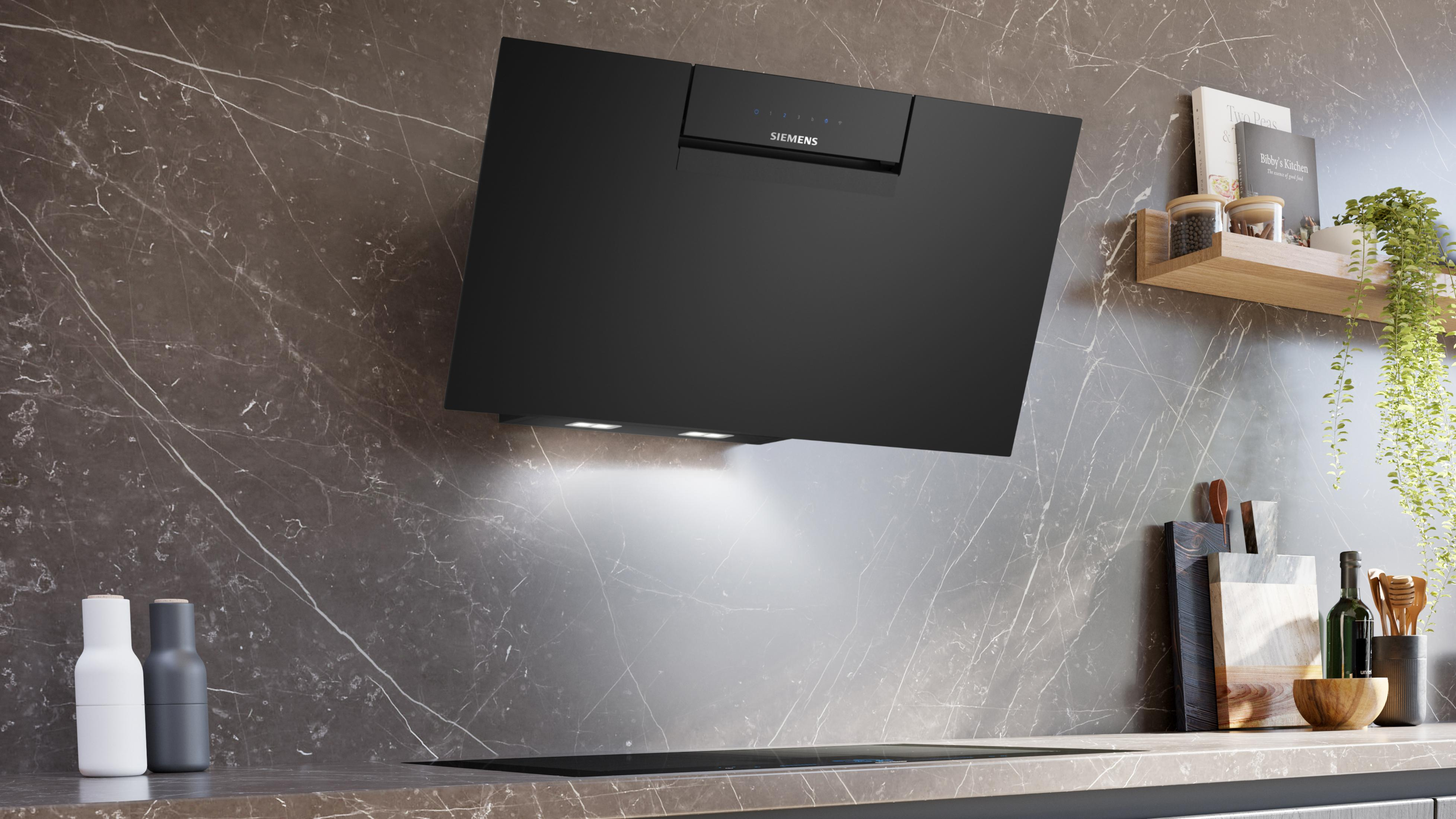 Black range hood mounted on a marble wall. It has lights and controls. A shelf with items is on the right.