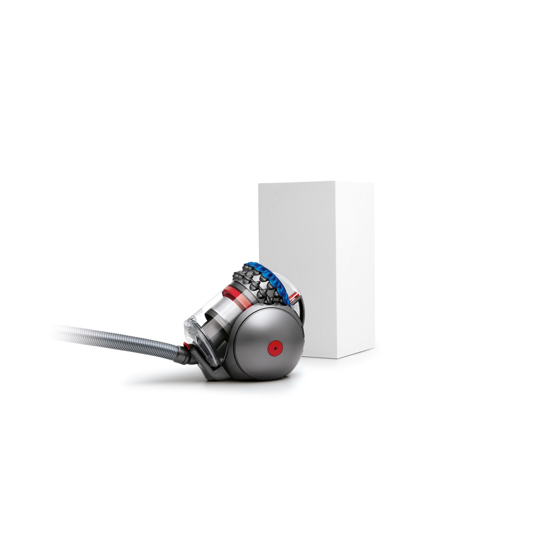 Aspirapolvere Dyson con sfera rossa, corpo grigio e tubo, accanto a una scatola bianca.