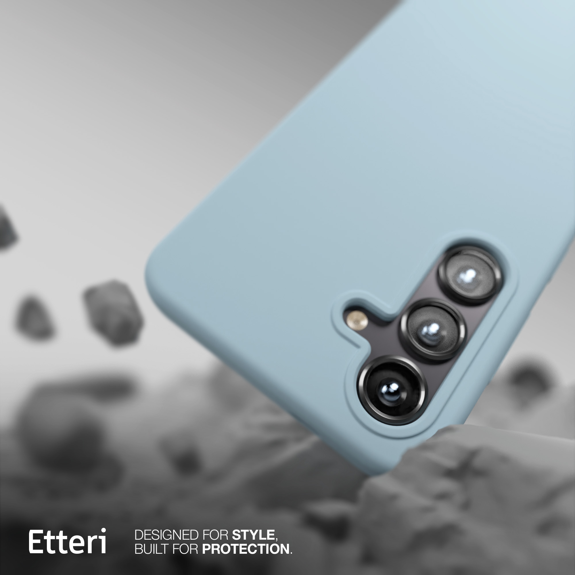 Custodia blu per telefono con obiettivi della fotocamera, posizionata su una superficie ruvida.