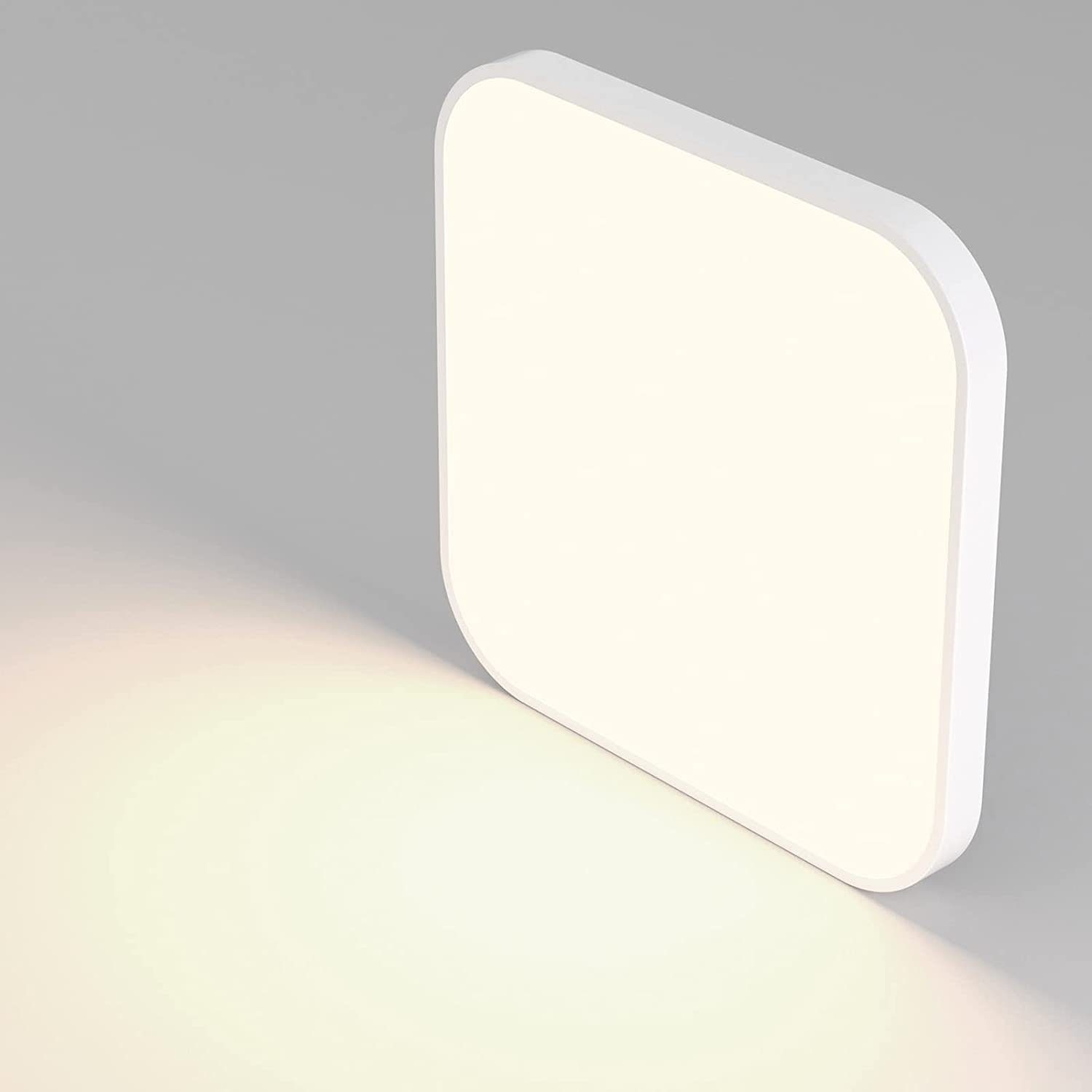 Eine weiße, quadratische LED-Leuchte mit abgerundeten Ecken, die Licht emittiert.