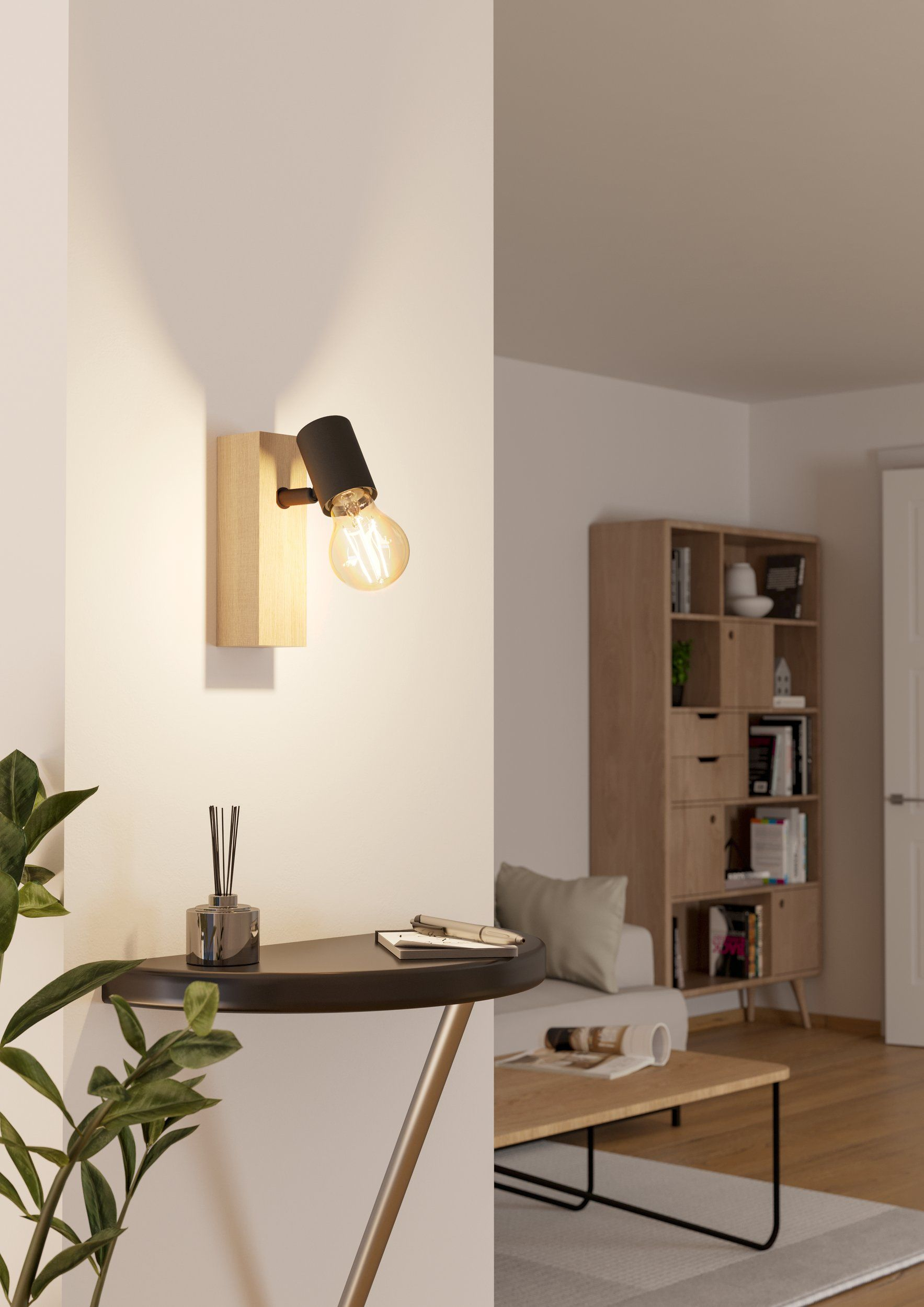 Eine Wand mit Holzblock, schwarzem Licht und sichtbarer Glühbirne. Tisch und Deko im Vordergrund.