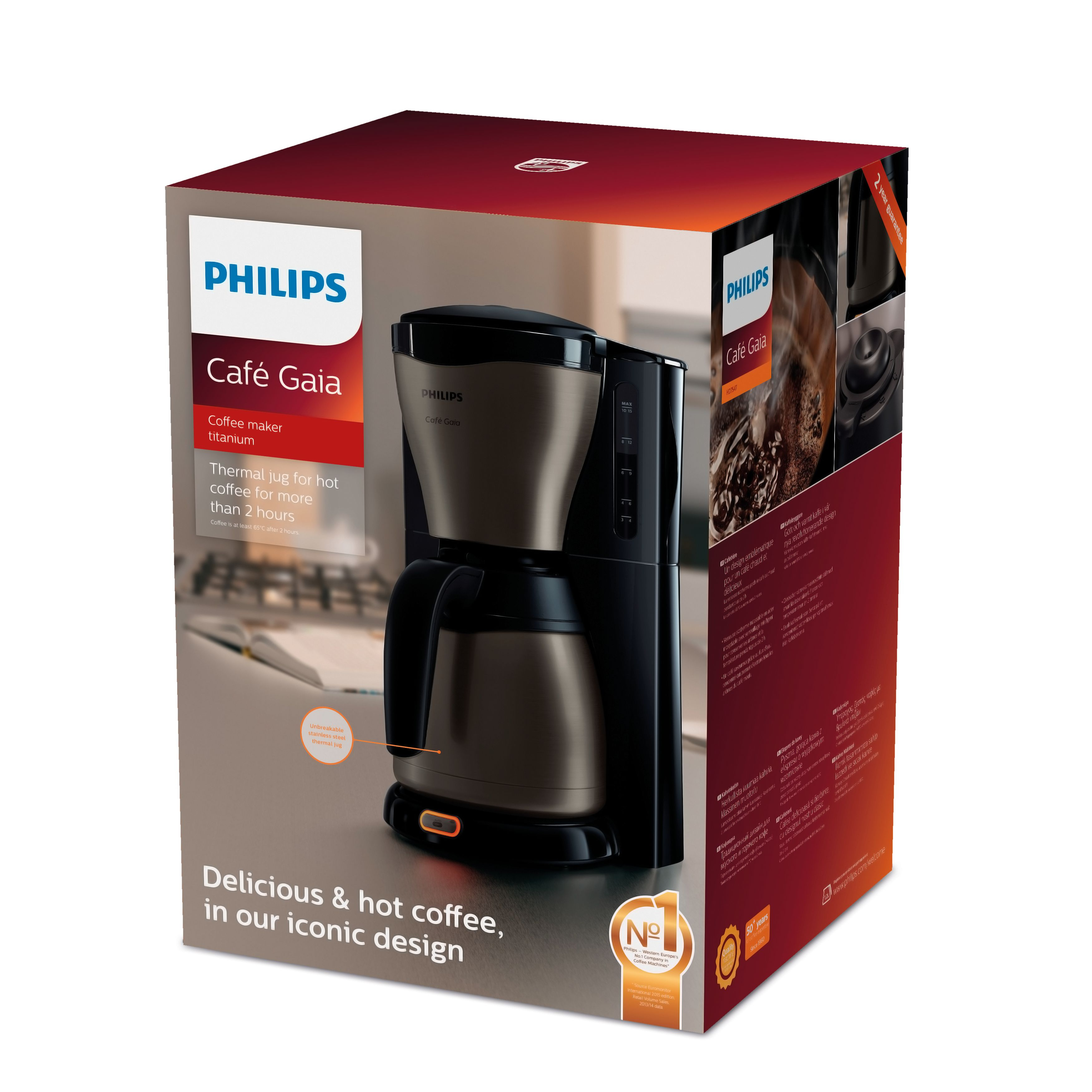 A coffee maker in a box with text. The coffee maker is black and silver, and the box has images of coffee.