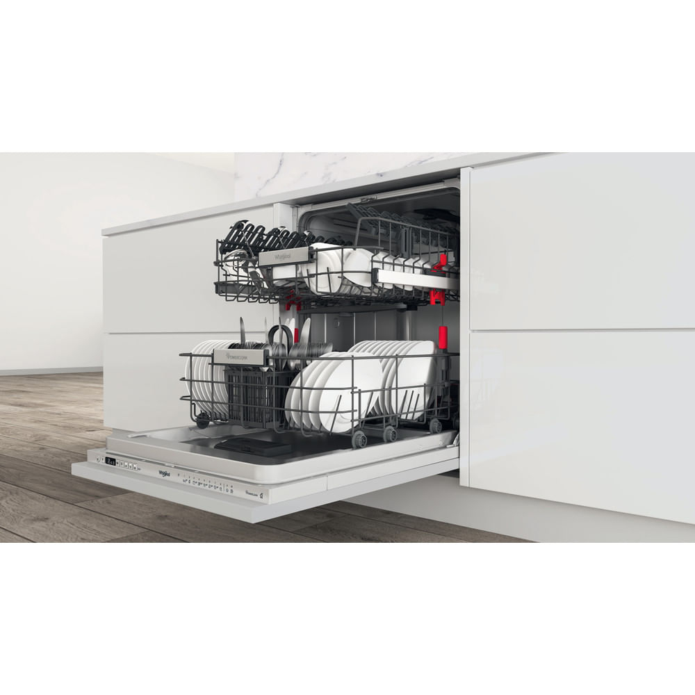 A dishwasher interior with racks, loaded with dishes and utensils, open and ready.