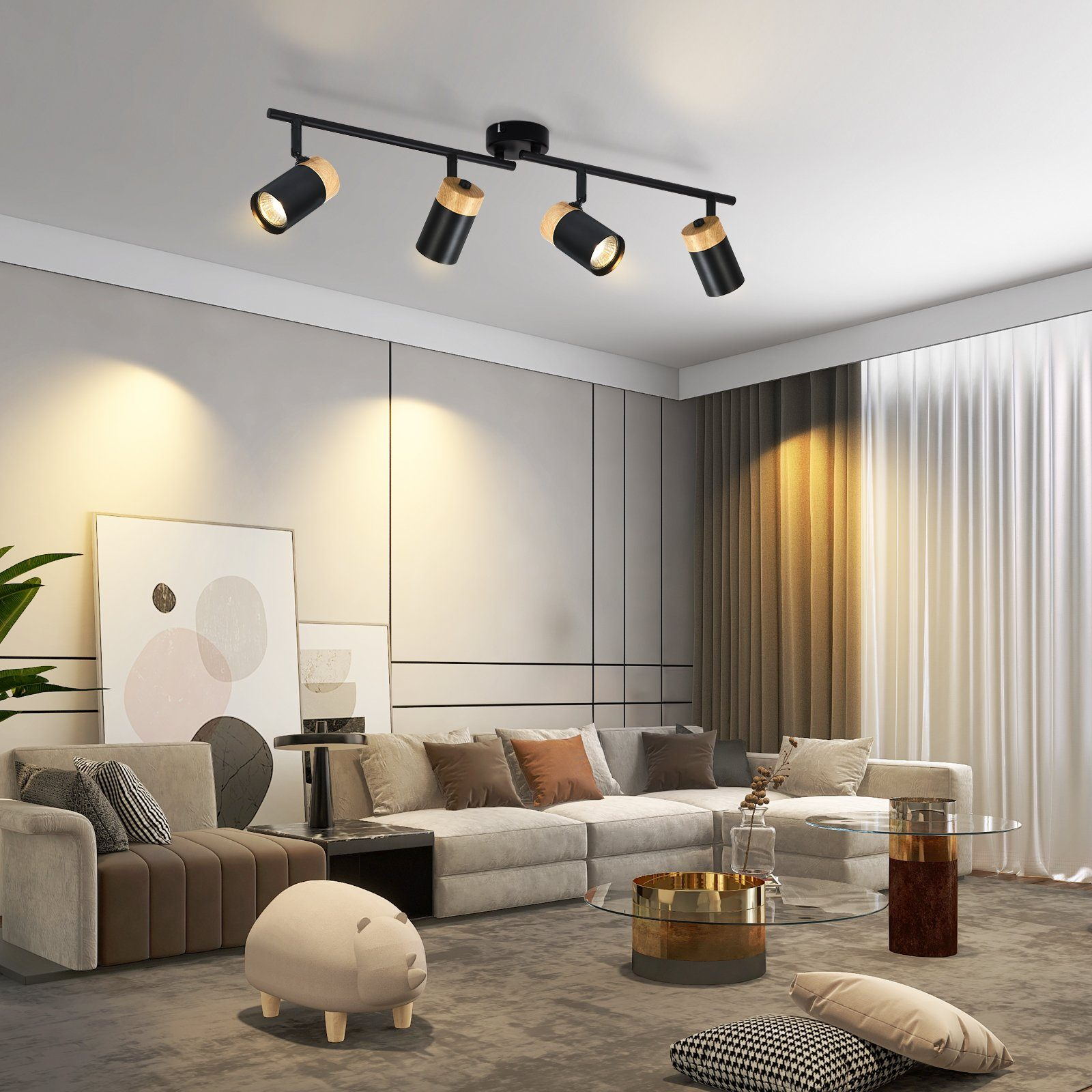 Un soggiorno moderno con divano grigio, opere d'arte e illuminazione a binario con faretti.