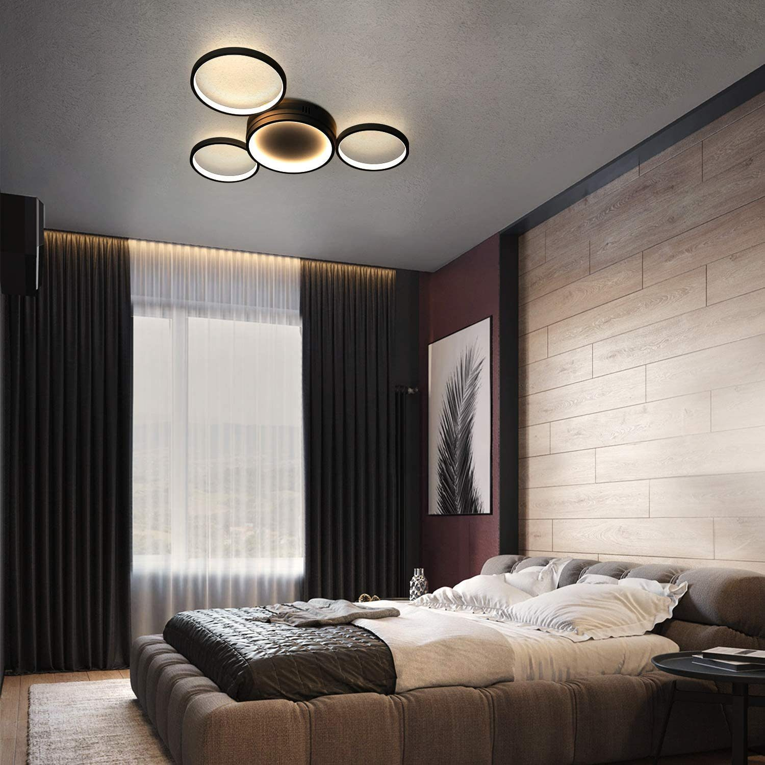 Schlafzimmer-Szene: Deckenleuchte, Bett, Vorhänge und Kunst. Leuchten sind kreisförmig und modern.