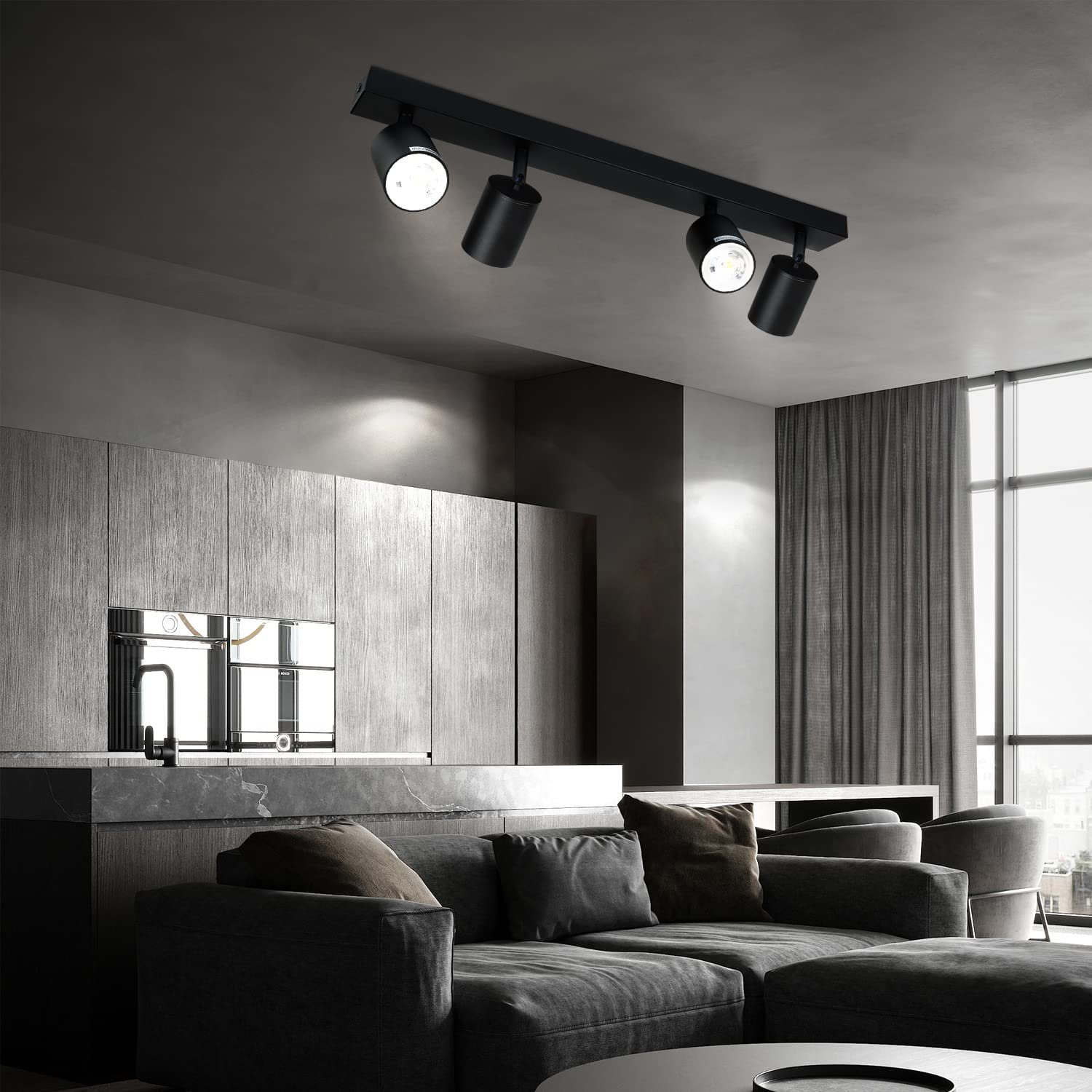 Eine schwarze Schienenbeleuchtung mit drei Strahlern. Die Leuchte ist an einer Decke in einem modernen Wohnzimmer montiert.