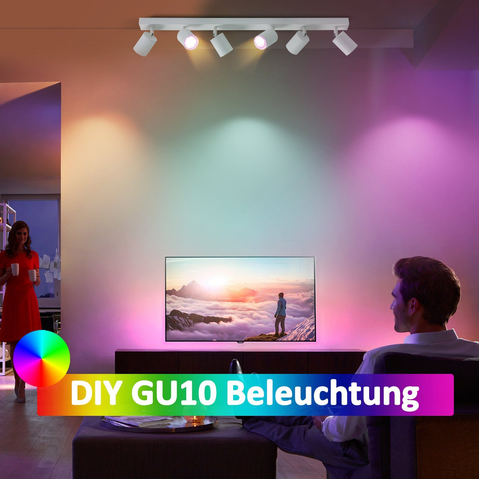 Una stanza con luci che cambiano colore, una TV e un uomo seduto.