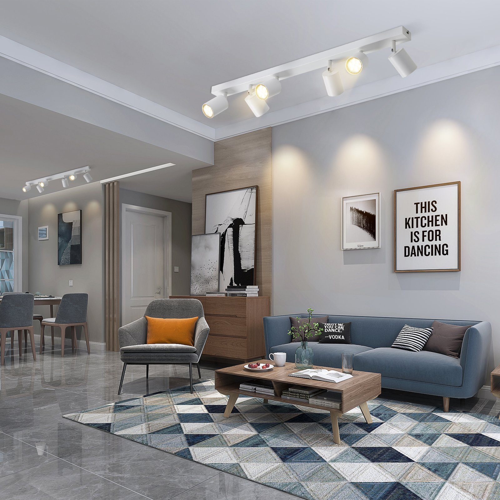 Un soggiorno con divano blu, tappeto e opere d'arte. Le luci a soffitto illuminano lo spazio, creando un'atmosfera moderna.