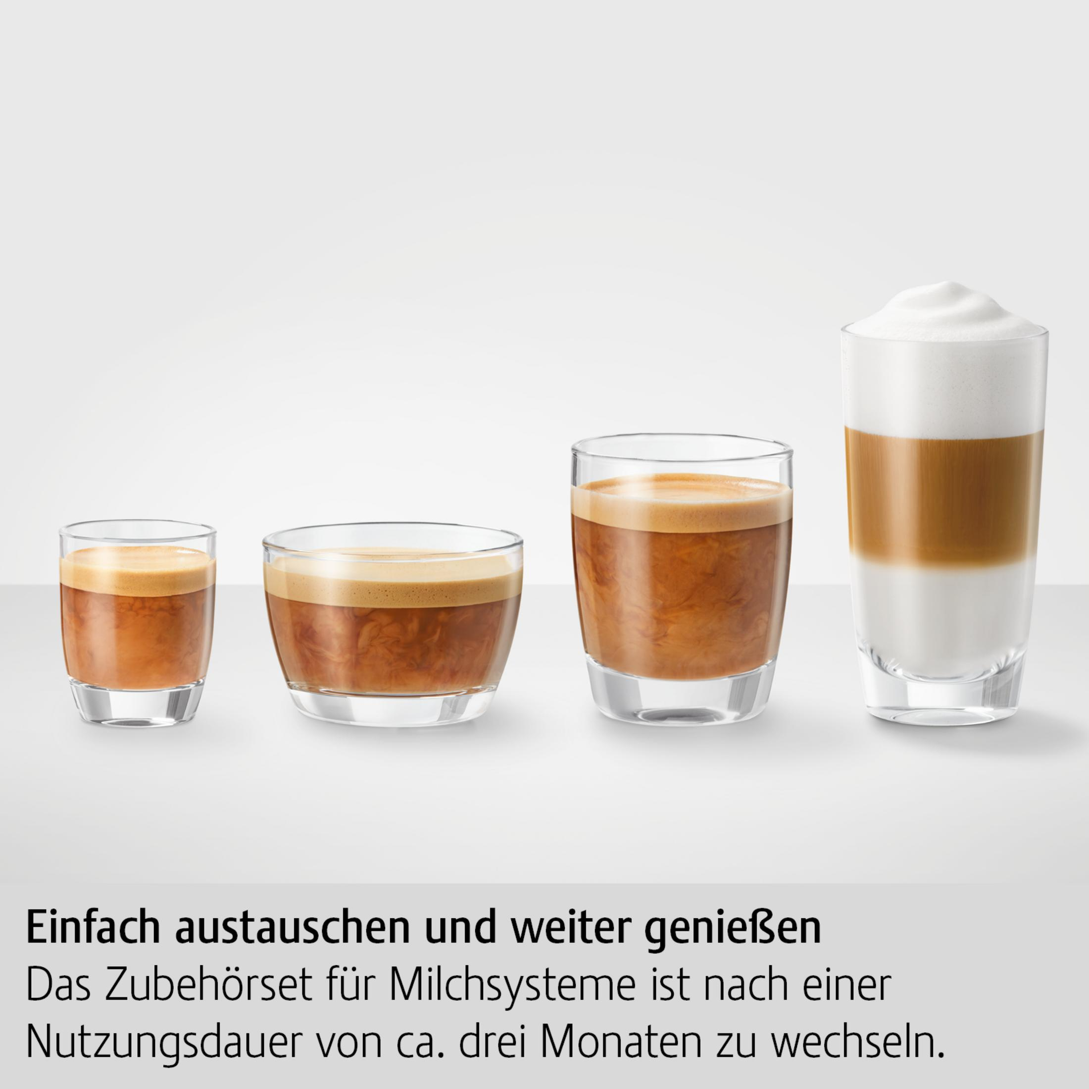 Four glasses of coffee, varying in size, with espresso and latte. Background: white.