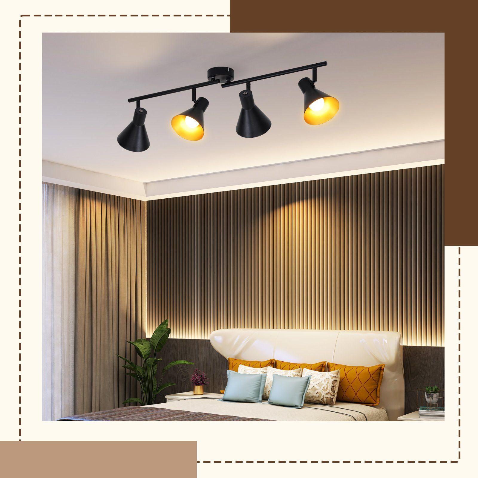Una stanza illuminata da una lampada a soffitto con quattro faretti neri, posta sopra un letto con cuscini.