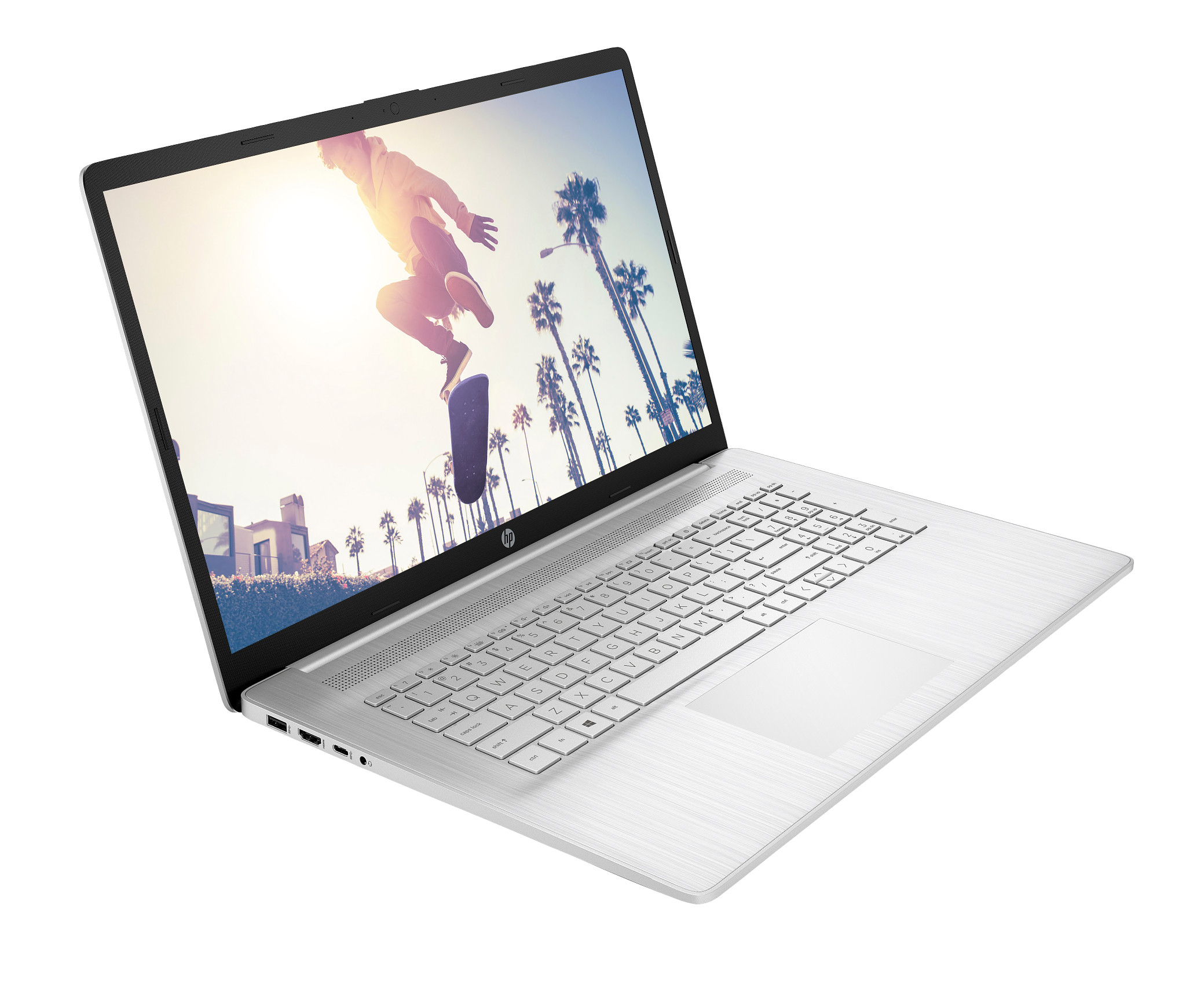 Srebrny laptop z otwartym ekranem, pokazujący osobę jeżdżącą na deskorolce przed palmami.