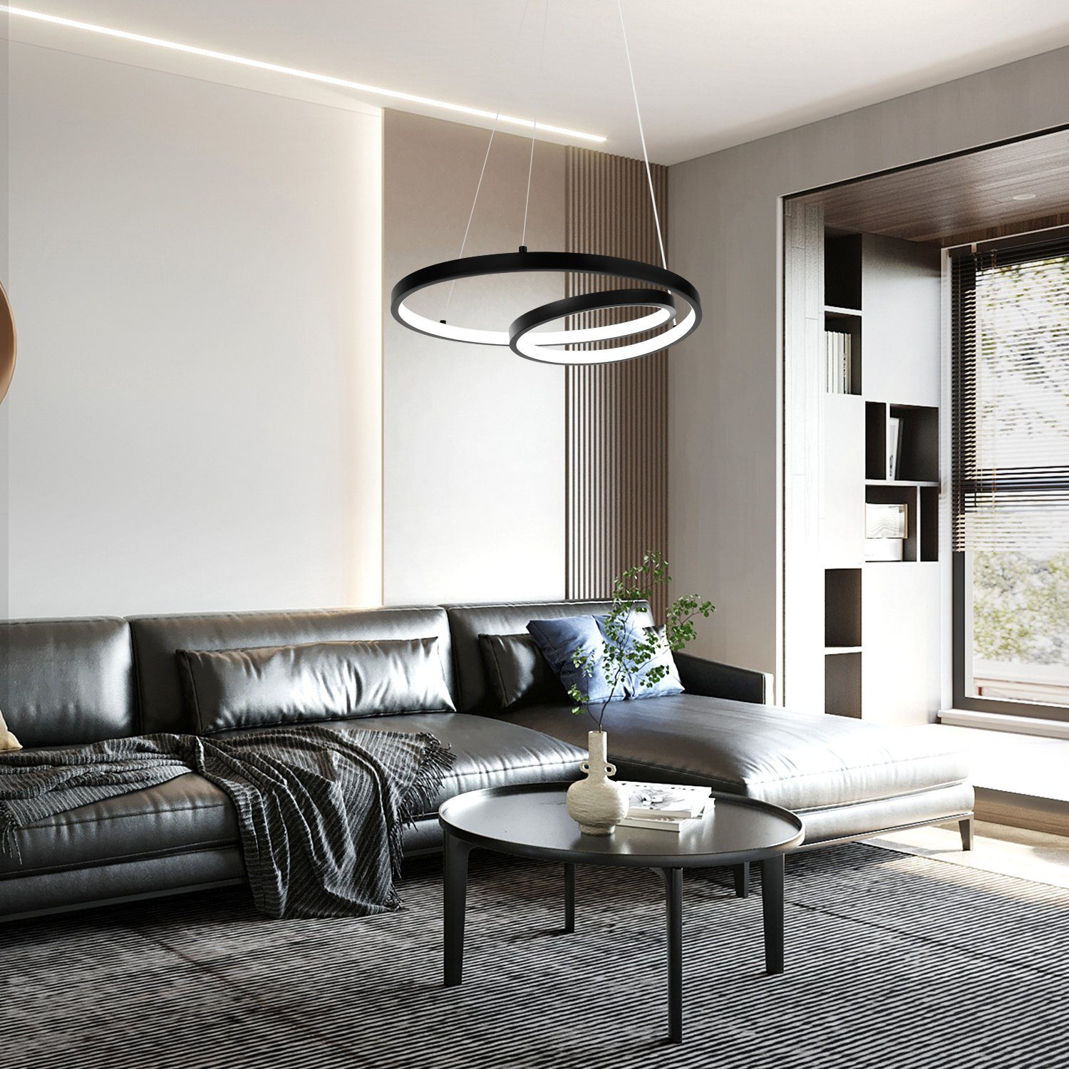 Nowoczesny salon z czarną skórzaną sofą, okrągłym stołem i lampami wiszącymi.