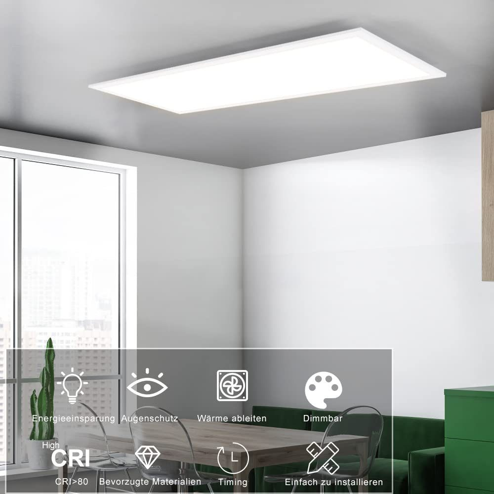 Biała prostokątna lampa sufitowa. Ma ikony dotyczące oszczędzania energii i innych funkcji. Białe tło.