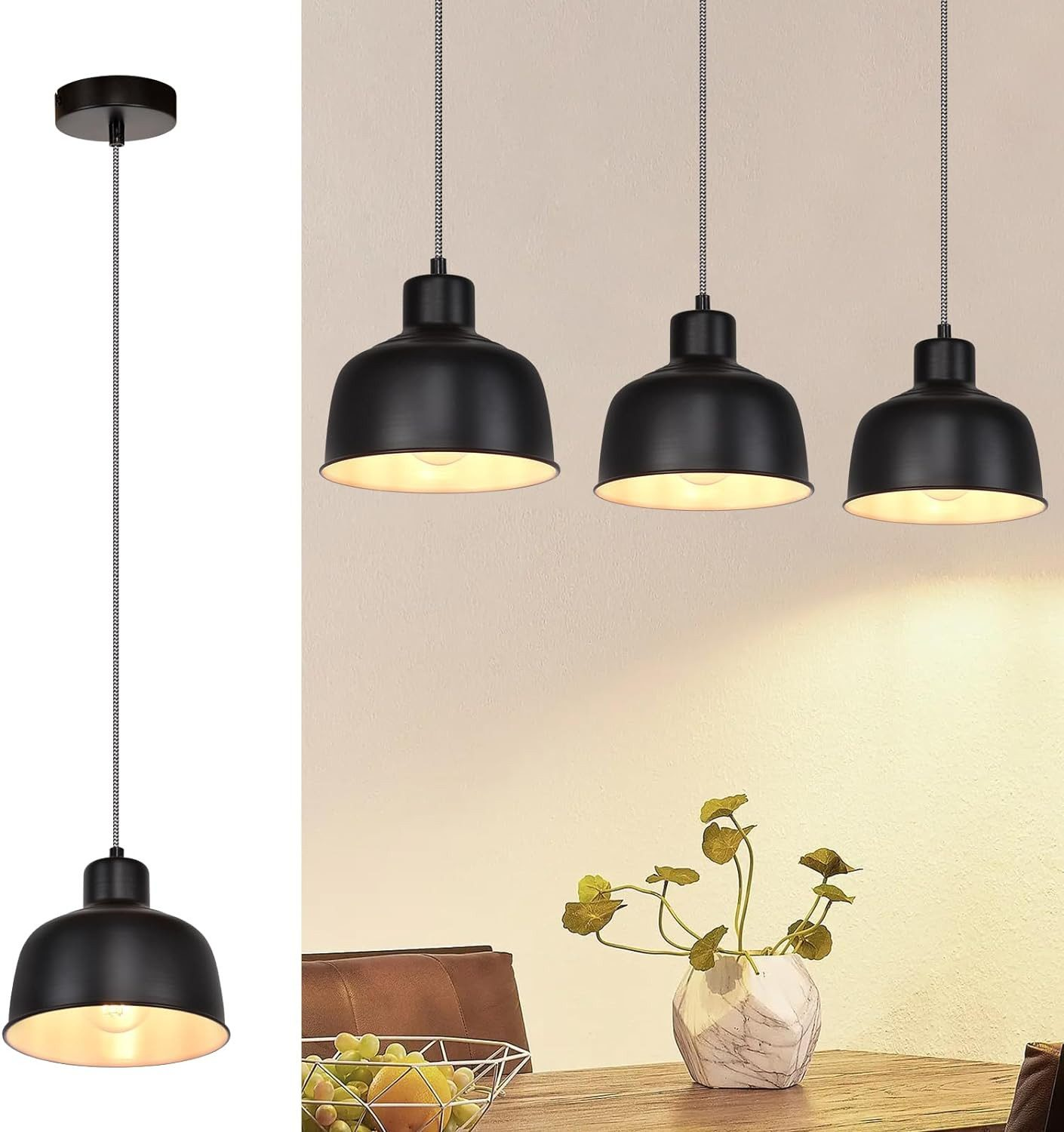 Trzy czarne lampy wiszące nad stołem. Wazon z roślinami na stole.