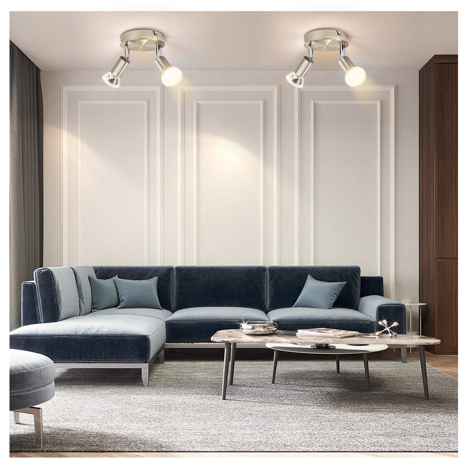 Due faretti argentati su un soffitto, che illuminano un soggiorno con mobili.