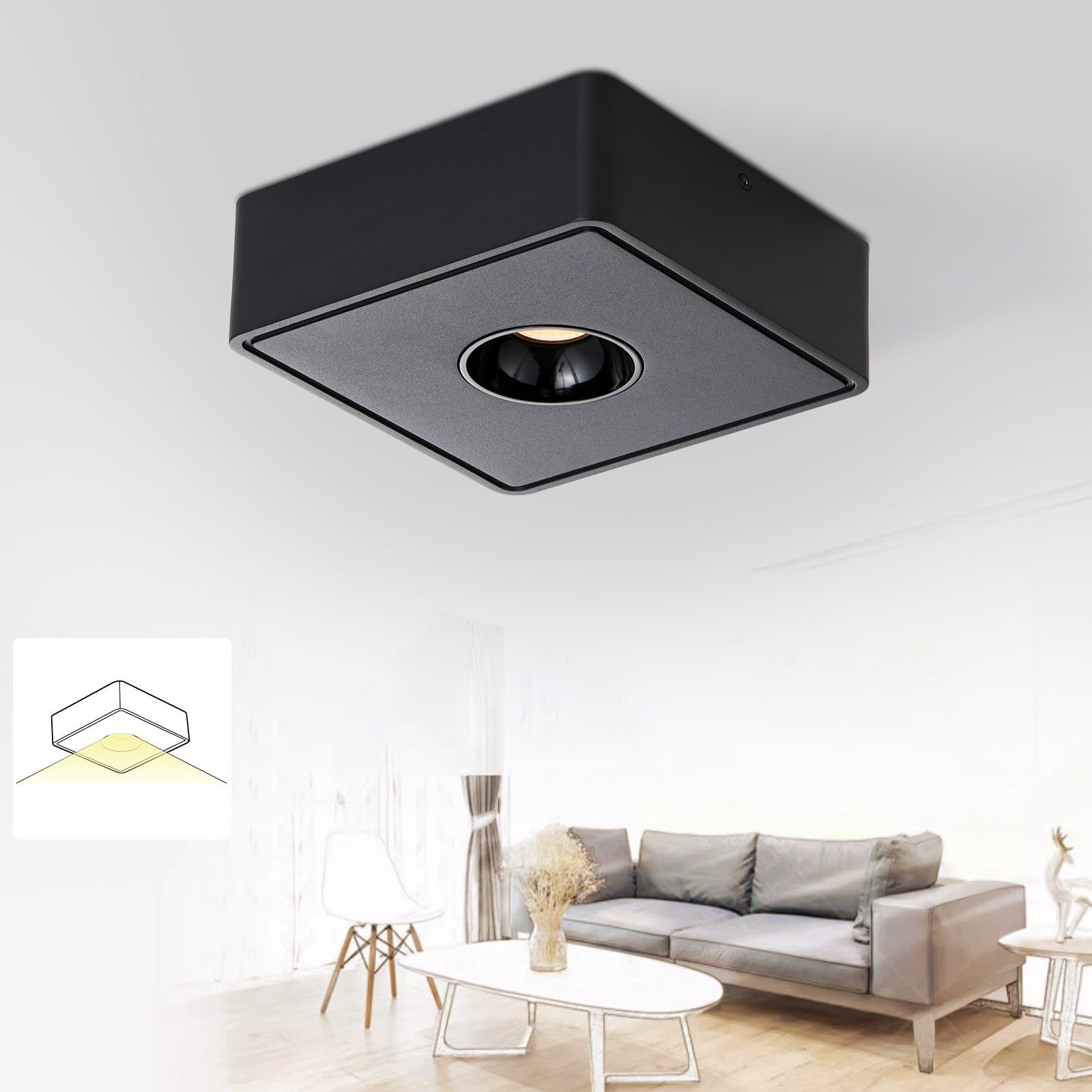 Lampada da soffitto quadrata nera. La luce è accesa, illumina l'area sottostante. Muri bianchi.