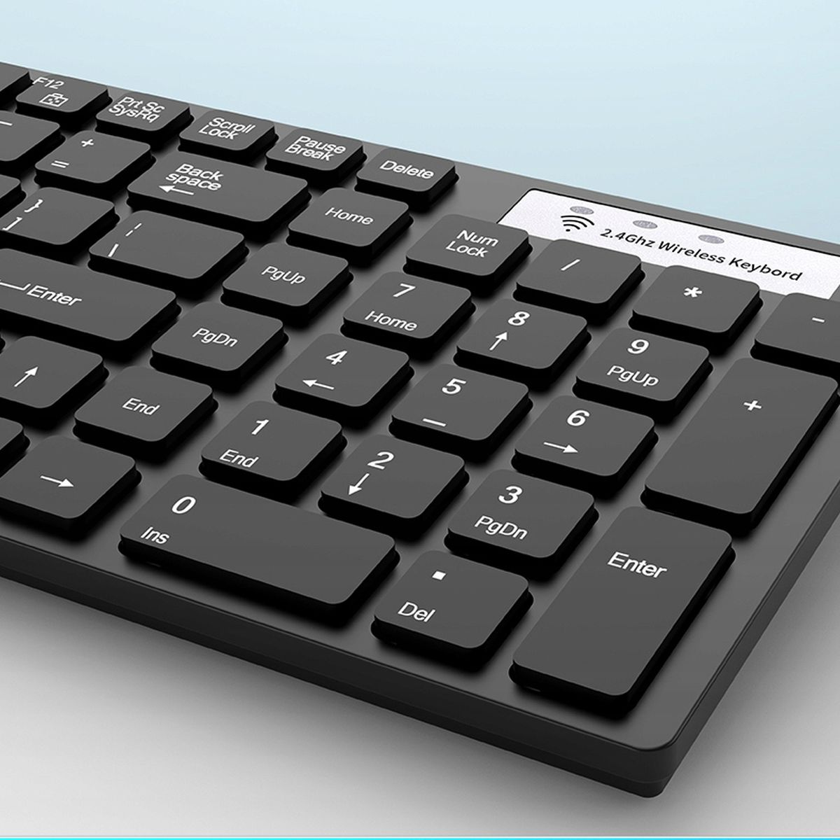 Zbliżenie czarnej klawiatury z białymi literami na klawiszach. Tło jest niebieskie.