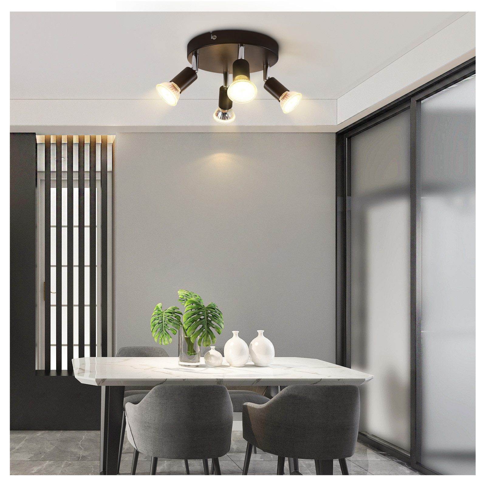 Lampa sufitowa z czterema reflektorami. Scena w jadalni ze stołem i krzesłami.