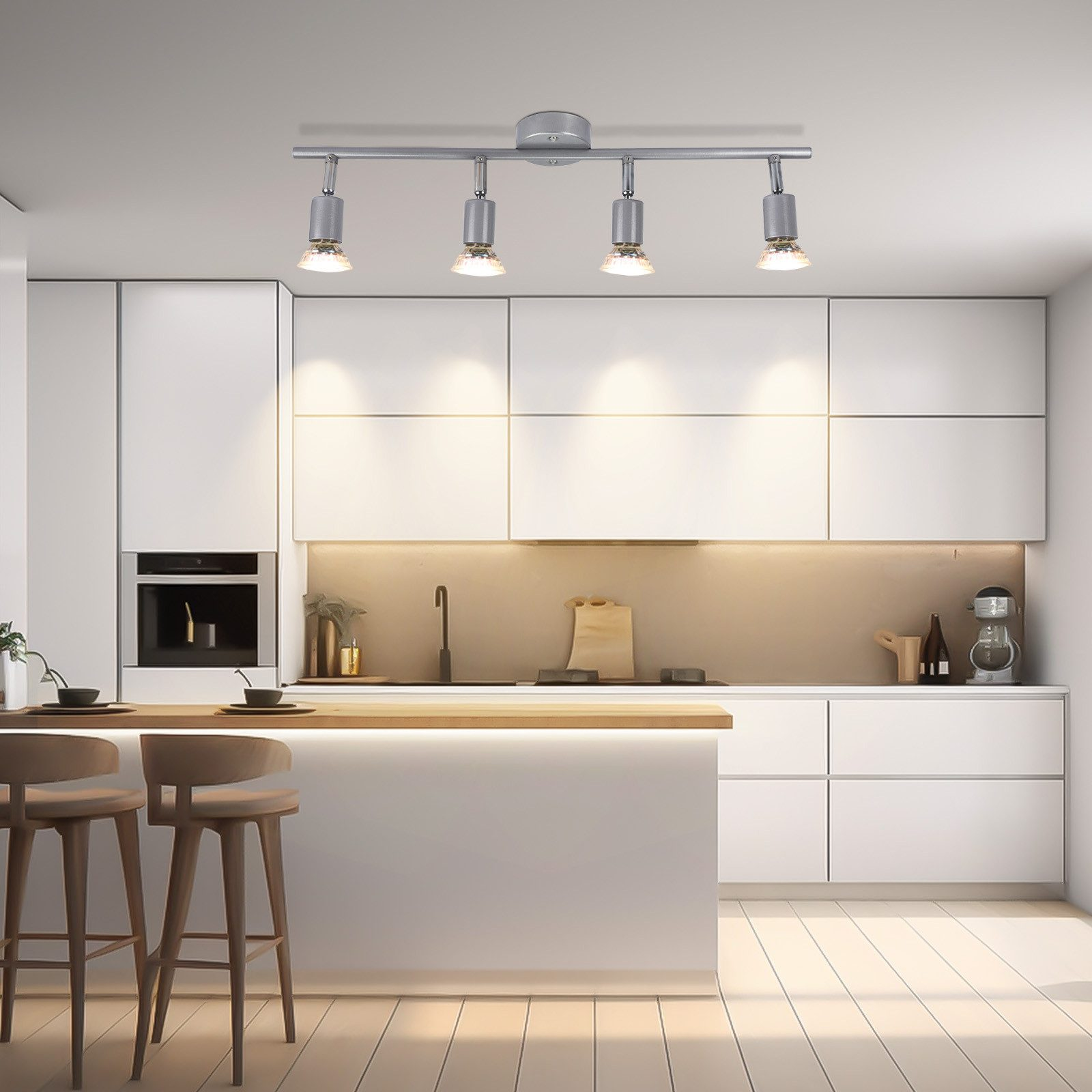 Nowoczesna kuchnia z białymi szafkami i oświetleniem. Widoczny drewniany blat.