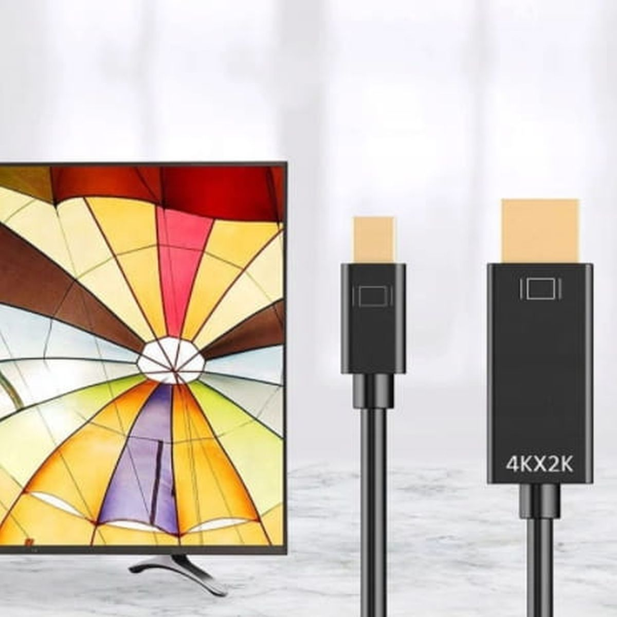 Ekran telewizora i dwa czarne kable HDMI.