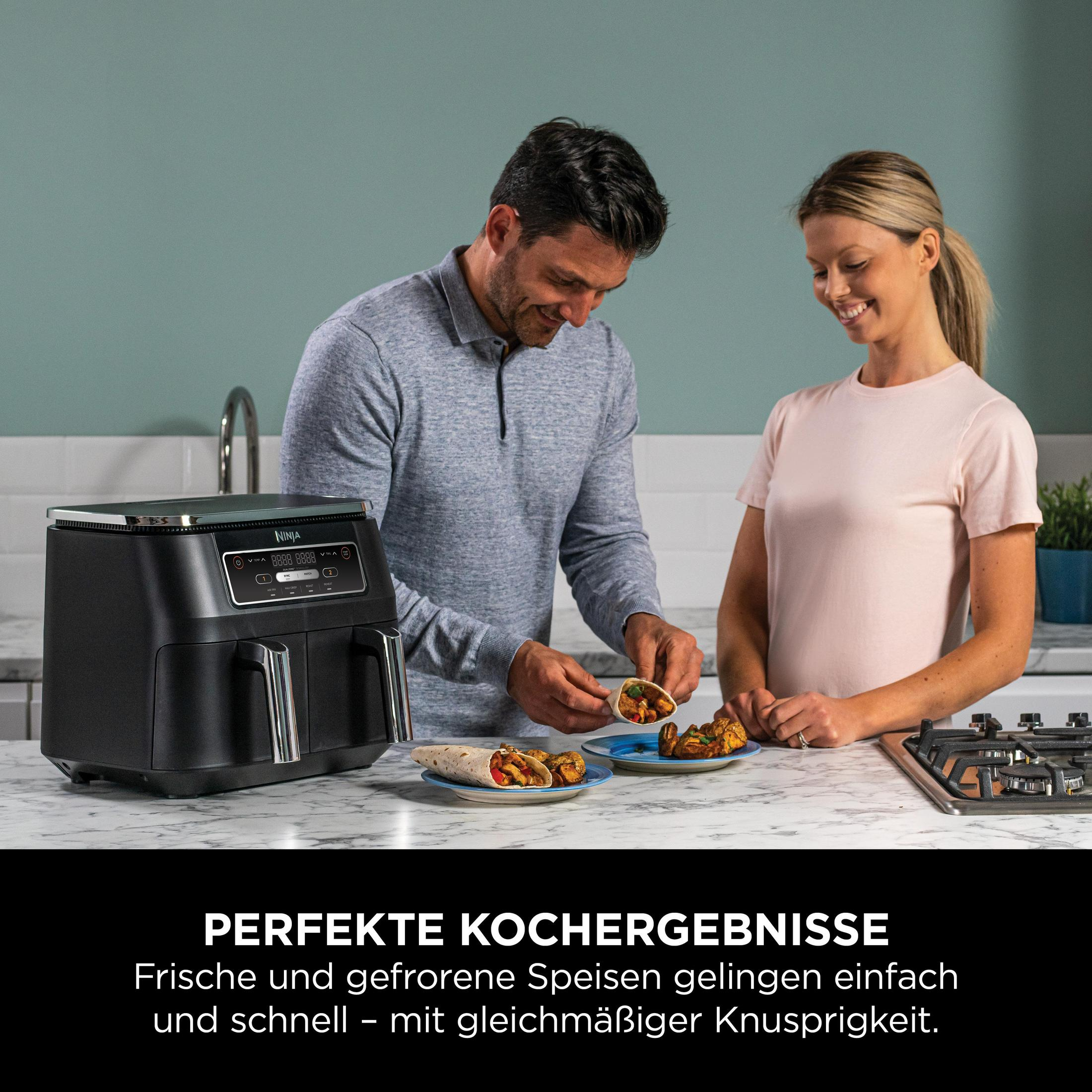 Para przygotowuje jedzenie, z frytownicą powietrzną na blacie.