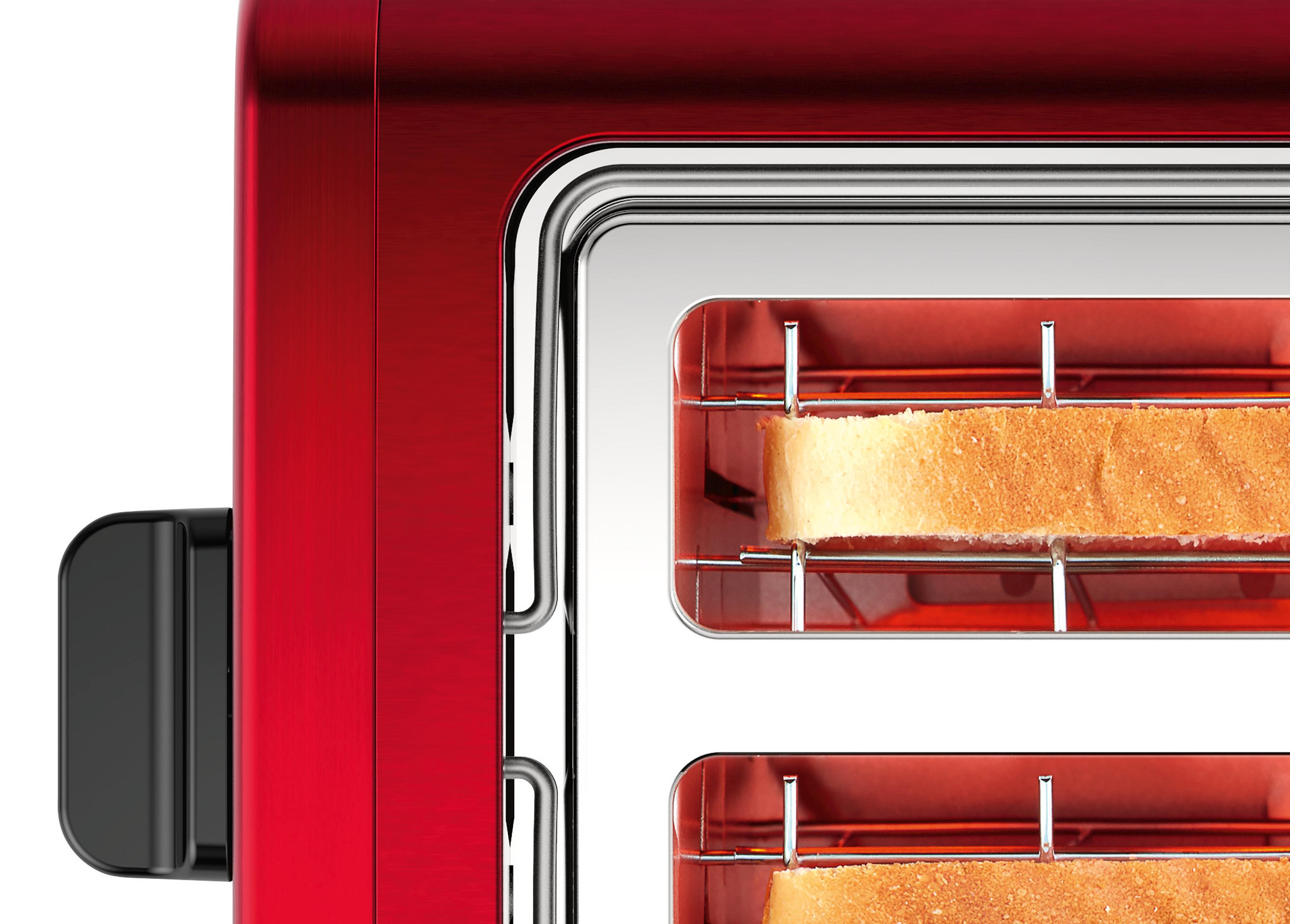 Ein roter Toaster mit zwei Toastscheiben im Inneren, Nahaufnahme.