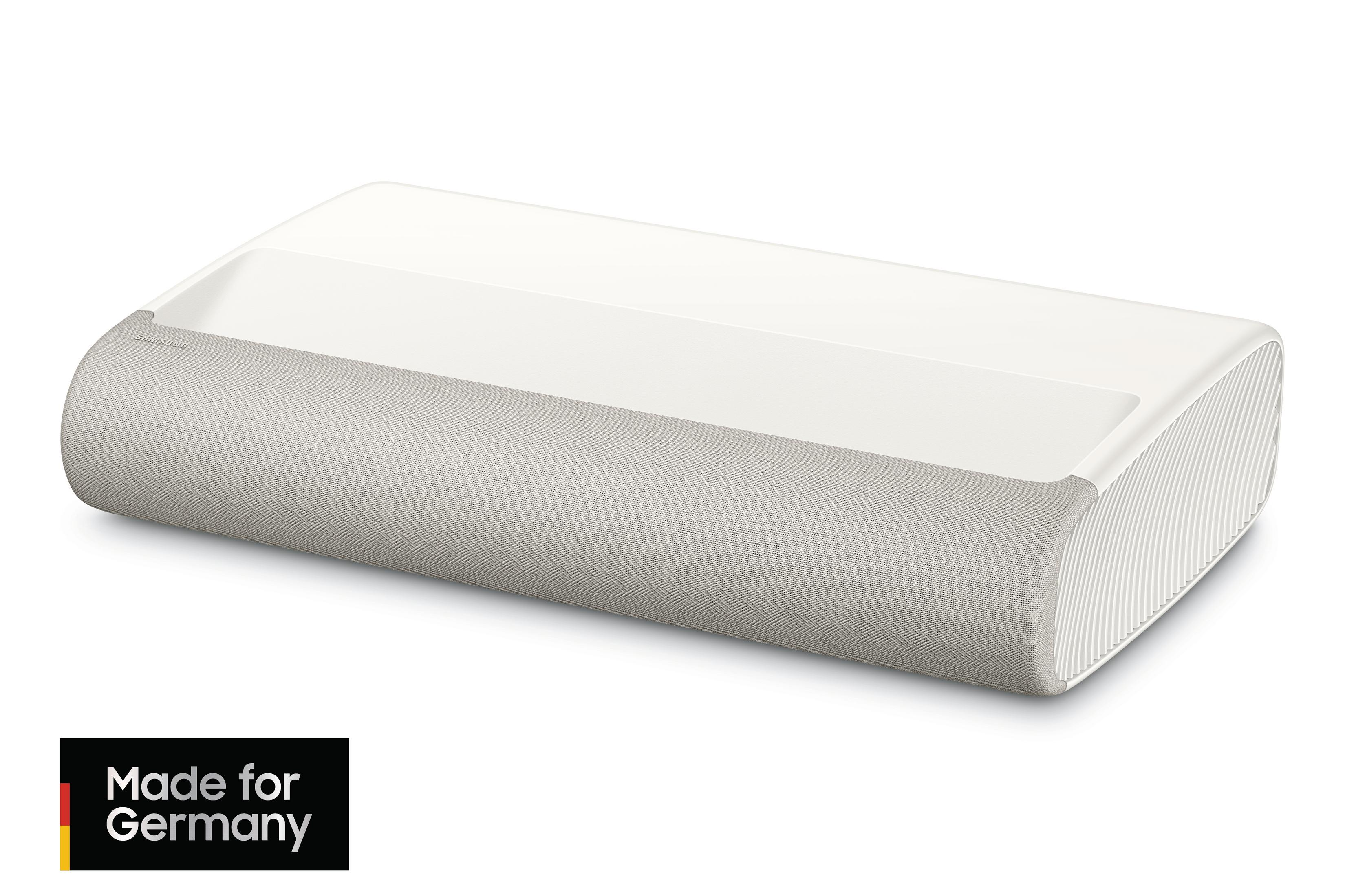 Biały projektor LG z jasnoszarym głośnikiem. Etykieta Made for Germany.