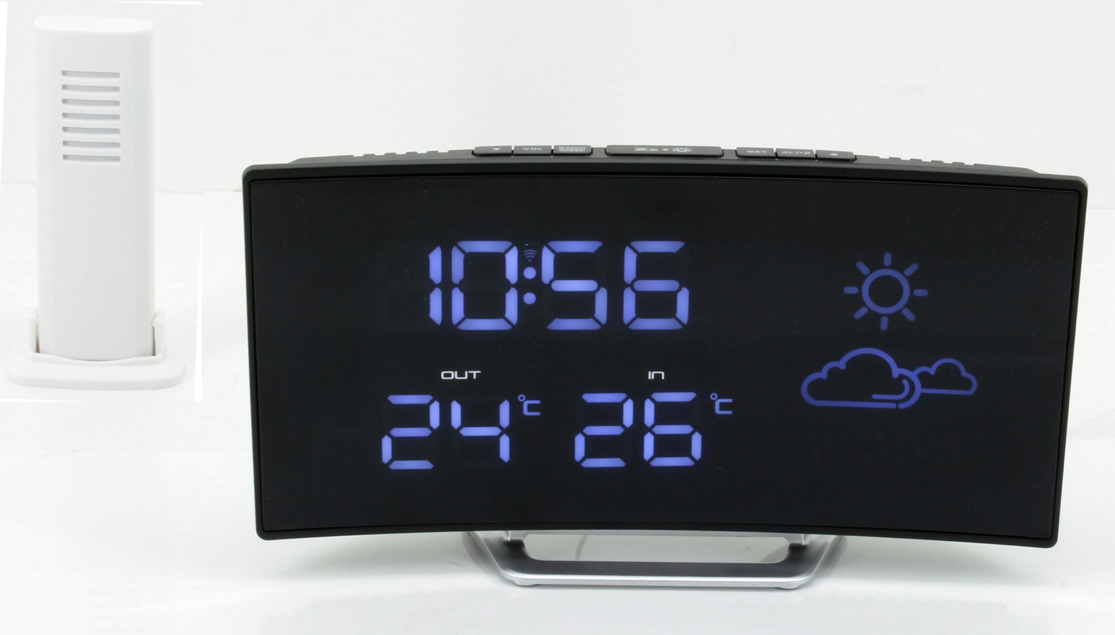 Orologio digitale nero mostra ora e temperatura con icone meteo su sfondo bianco.