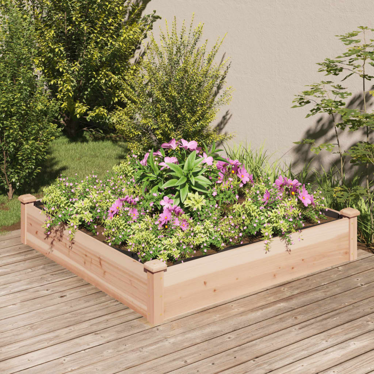 Erhöhtes Gartenbeet aus Holz mit rosa Blumen und grünen Pflanzen auf einem Holzdeck.
