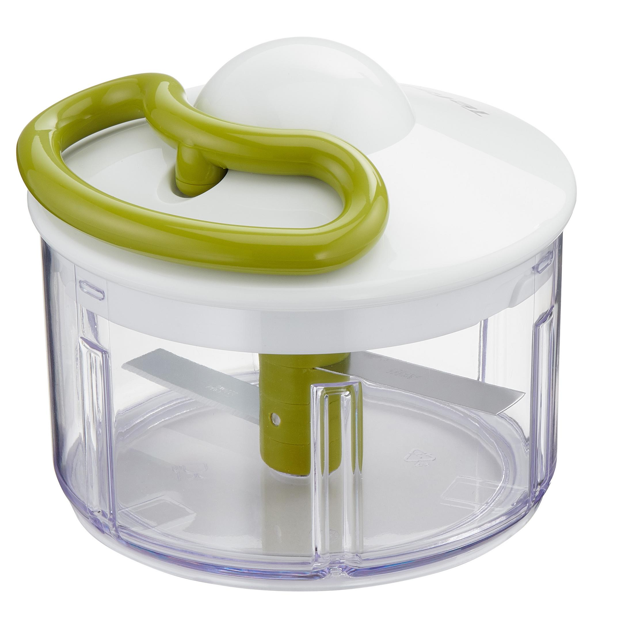 Un tritatutto manuale con un coperchio bianco, un manico verde e un contenitore trasparente con lame.