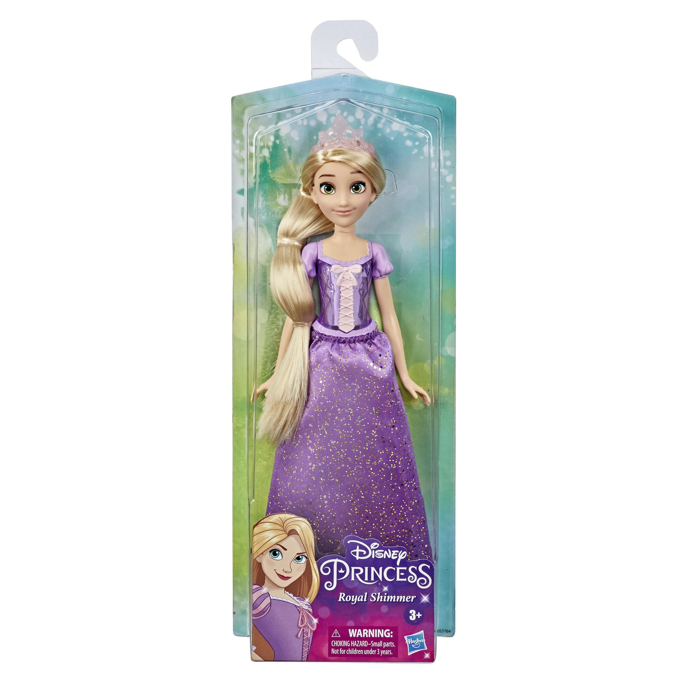 Bambola nella confezione; vestito viola, lunghi capelli biondi, tiara. Sfondo sfumato verde e bianco.