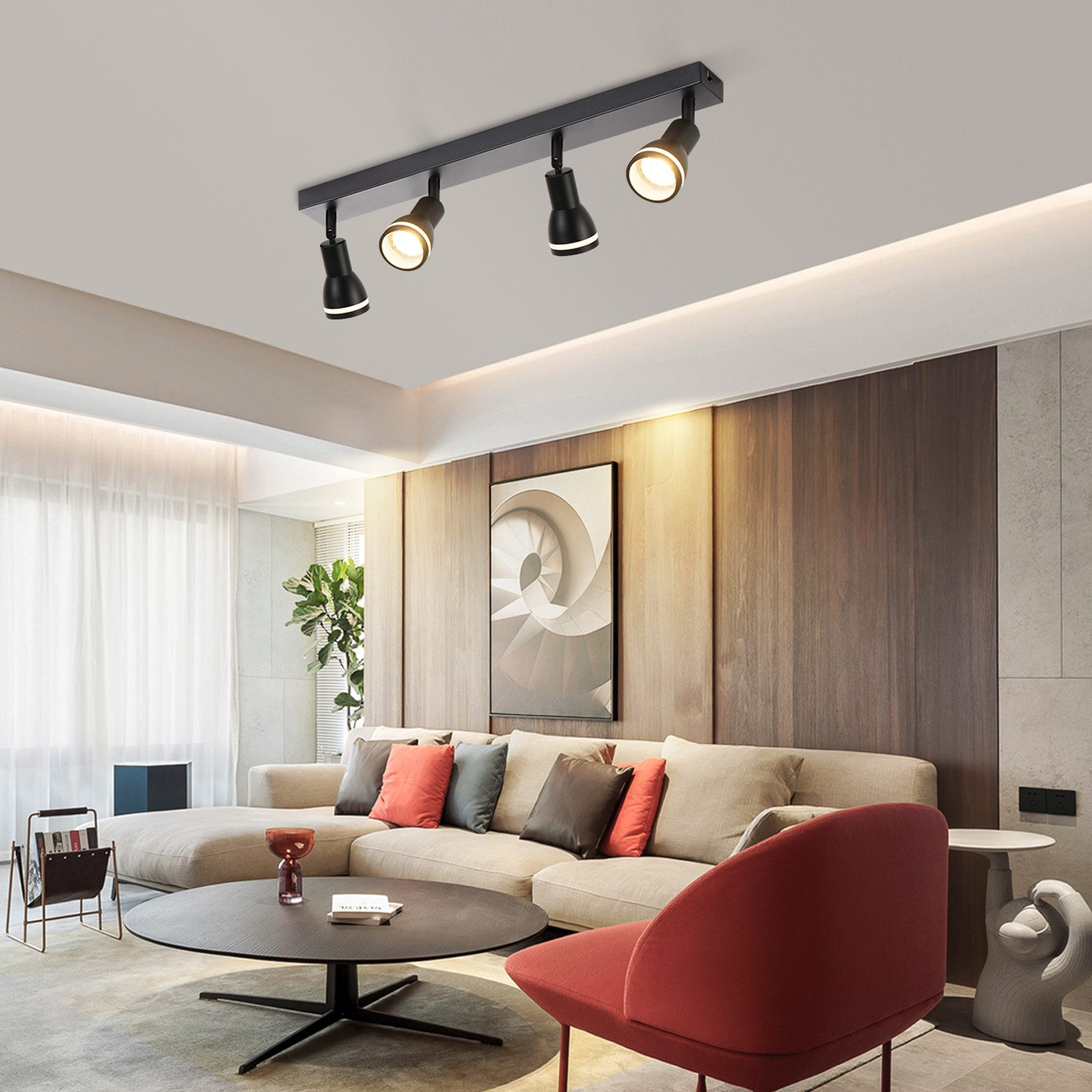 Un moderno soggiorno con un'apparecchio di illuminazione a binario nero sul soffitto, che illumina lo spazio.